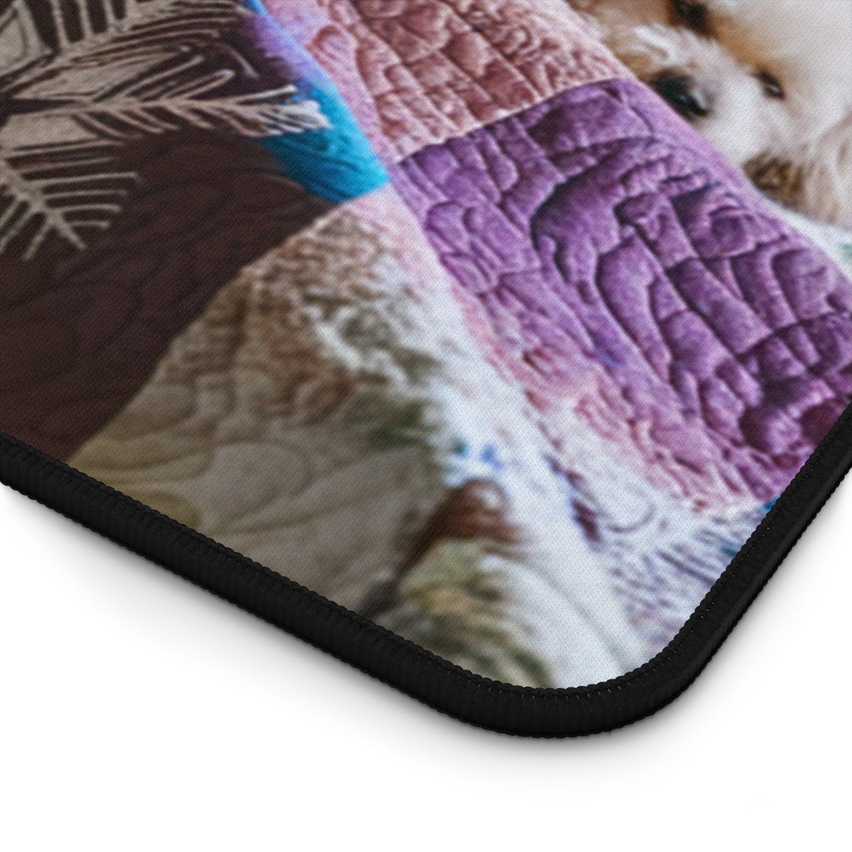 A quilting inspired Desk pad featuring a small white dog curled up on a winter-themed quilt. The quilt displays intricate snowflake patterns in shades of blue, purple, and white, creating a cozy and calming winter scene for your workspace. Perfect gift for quilters.