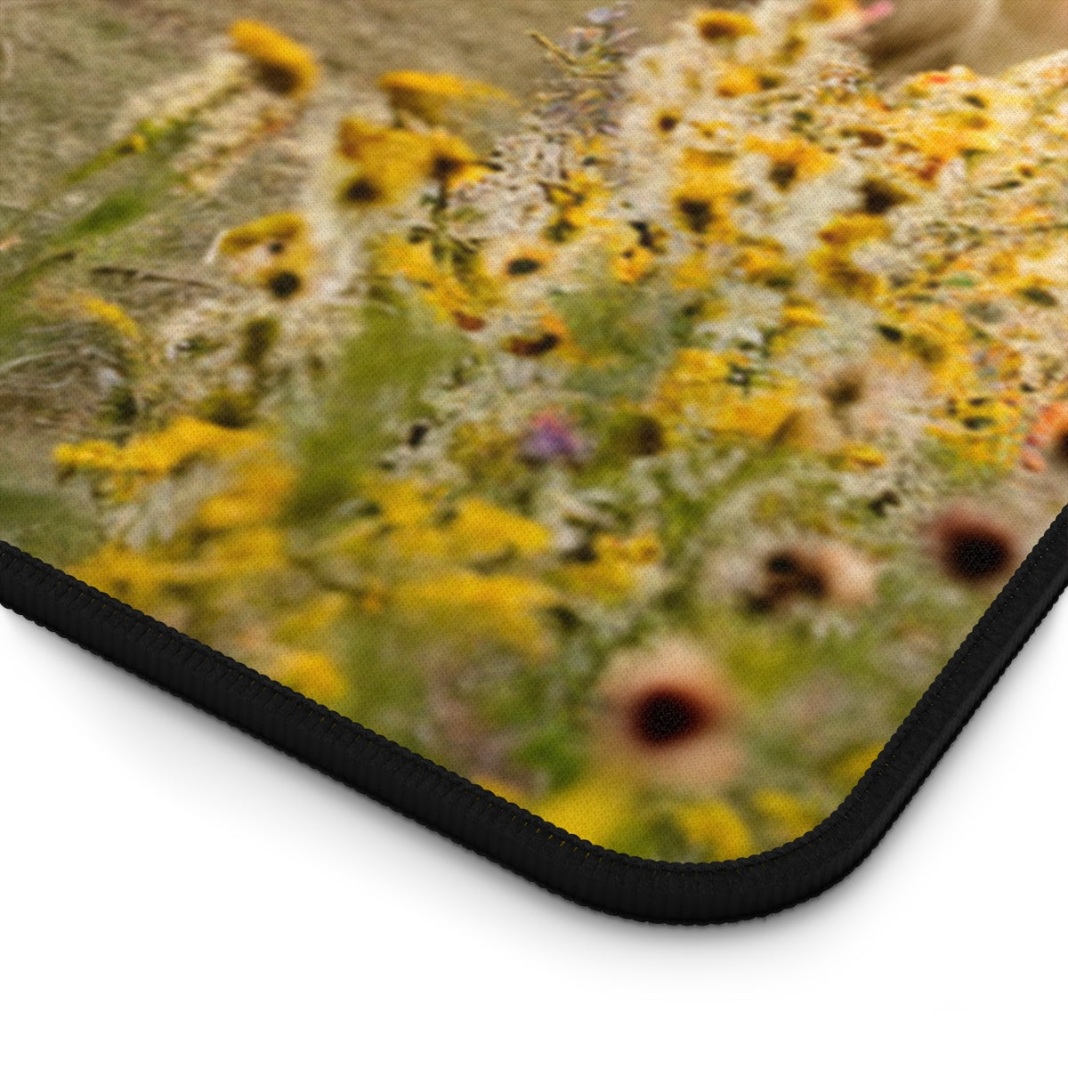 A quilting inspired Desk pad featuring a quilt draped over hay bales in a field at sunset. Sheep graze in the background amidst golden wildflowers. The quilt features a soft, geometric pattern in pastel colors. Perfect gift for quilters.