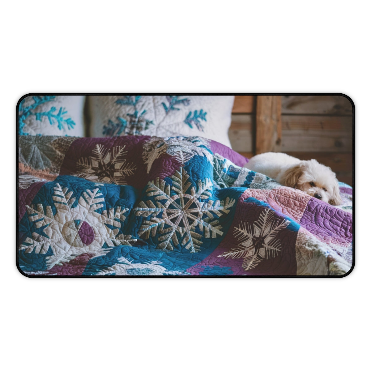 A quilting inspired Desk pad featuring a small white dog curled up on a winter-themed quilt. The quilt displays intricate snowflake patterns in shades of blue, purple, and white, creating a cozy and calming winter scene for your workspace. Perfect gift for quilters.