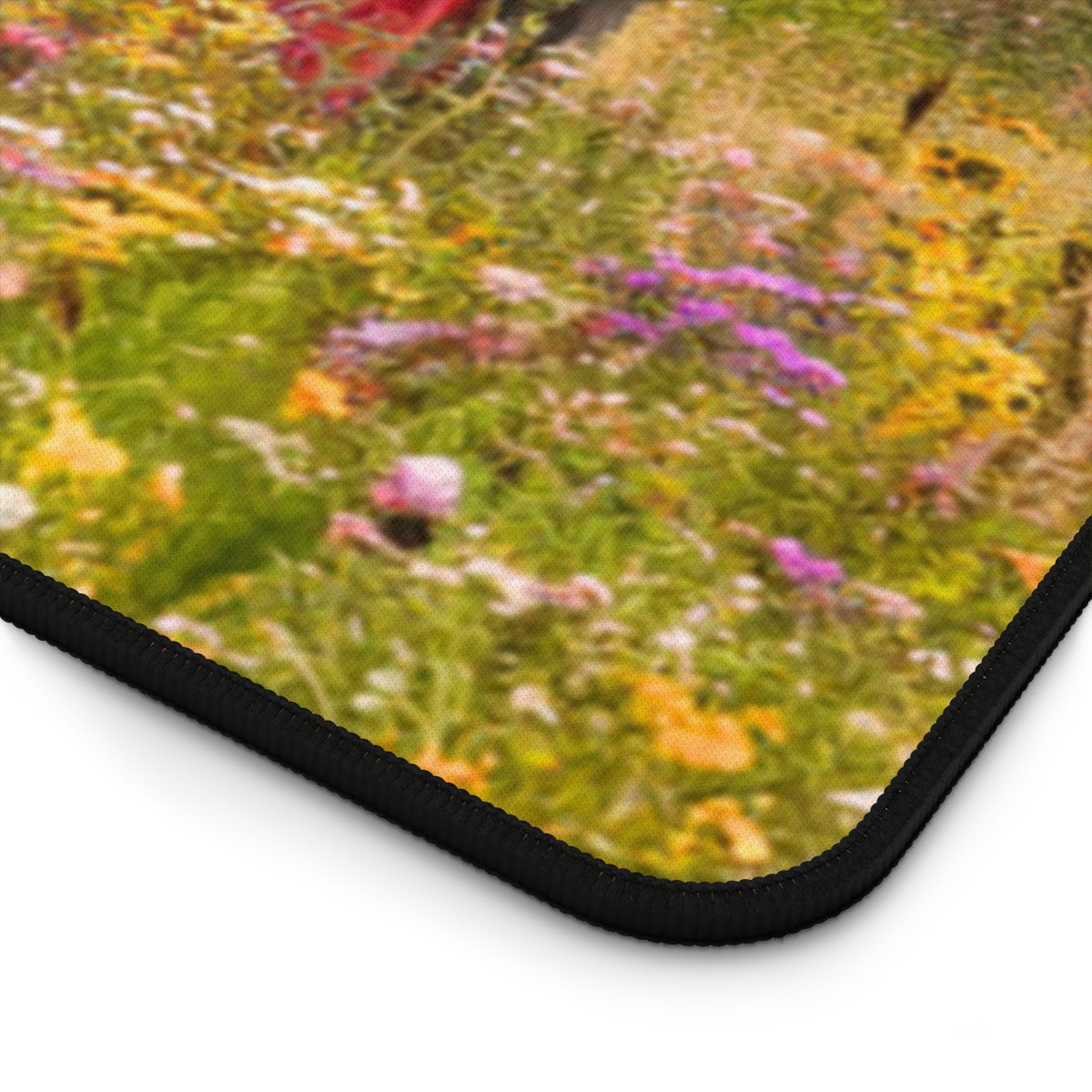 A quilting inspired Desk pad featuring a Vintage  tractor in a wildflower field, partially covered by a colorful patchwork quilt. Golden wheat stalks and a sunset sky create a warm, countryside atmosphere. Perfect gift for quilters.