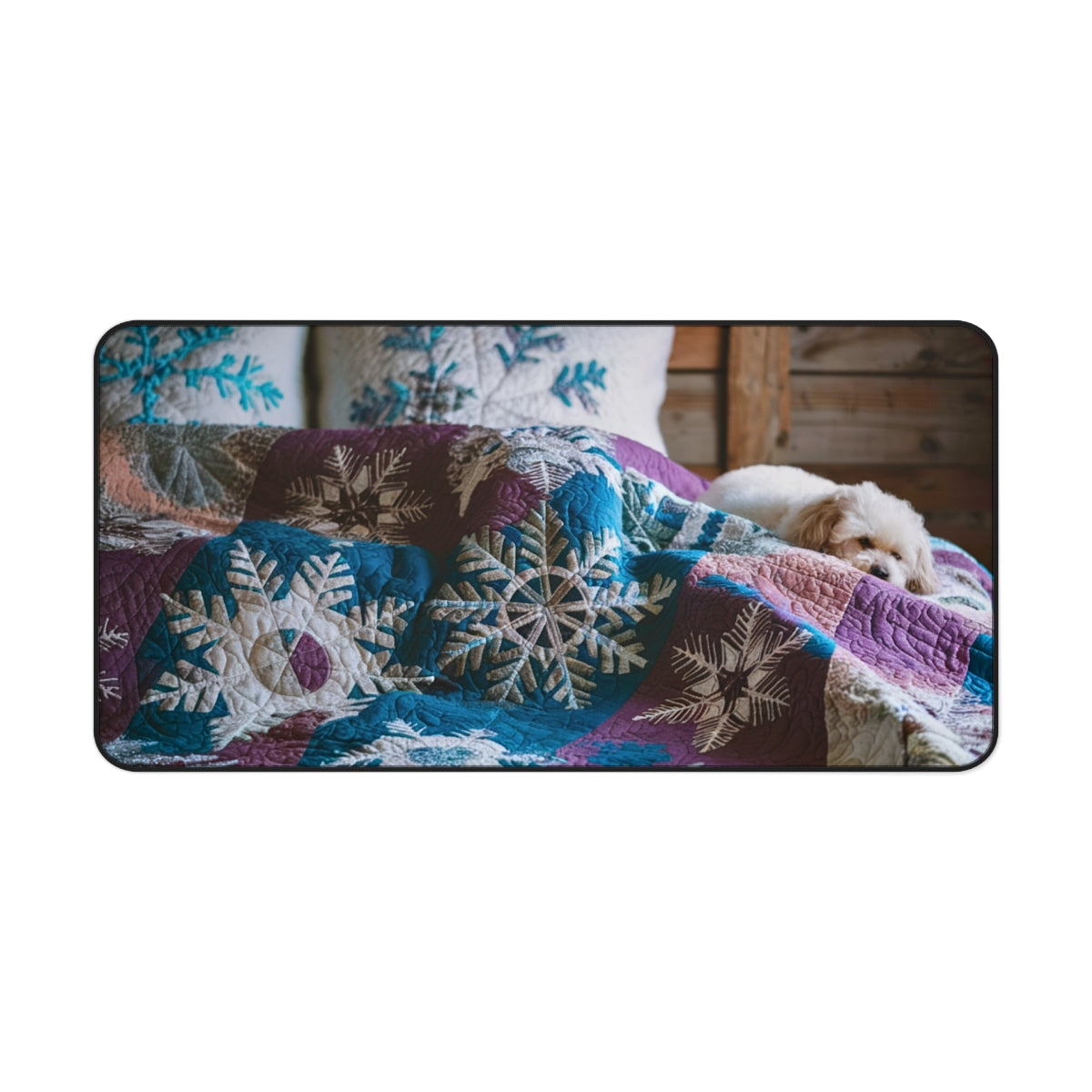A quilting inspired Desk pad featuring a small white dog curled up on a winter-themed quilt. The quilt displays intricate snowflake patterns in shades of blue, purple, and white, creating a cozy and calming winter scene for your workspace. Perfect gift for quilters.