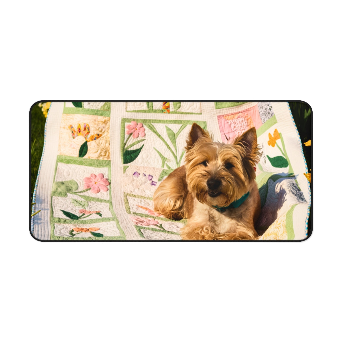 A quilting inspired Desk pad design showing a terrier puppy sitting on a colorful spring-themed quilt with various flower patterns. The quilt features pink, yellow, and green patches with intricate floral designs, creating a cheerful and vibrant workspace accessory. Perfect gift for quilters.