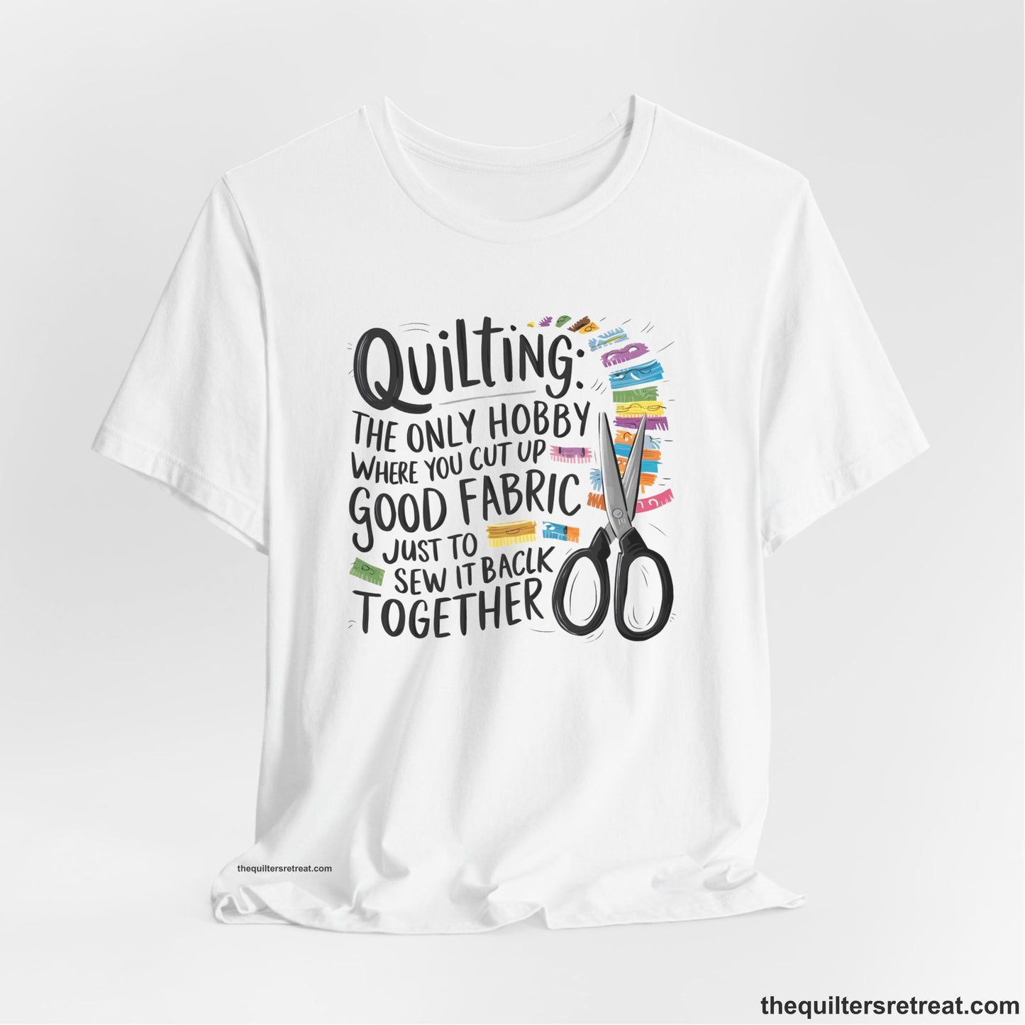 A White Short Sleeve T-Shirt with a quilting-themed text with colorful fabric pieces and scissors in a whimsical style