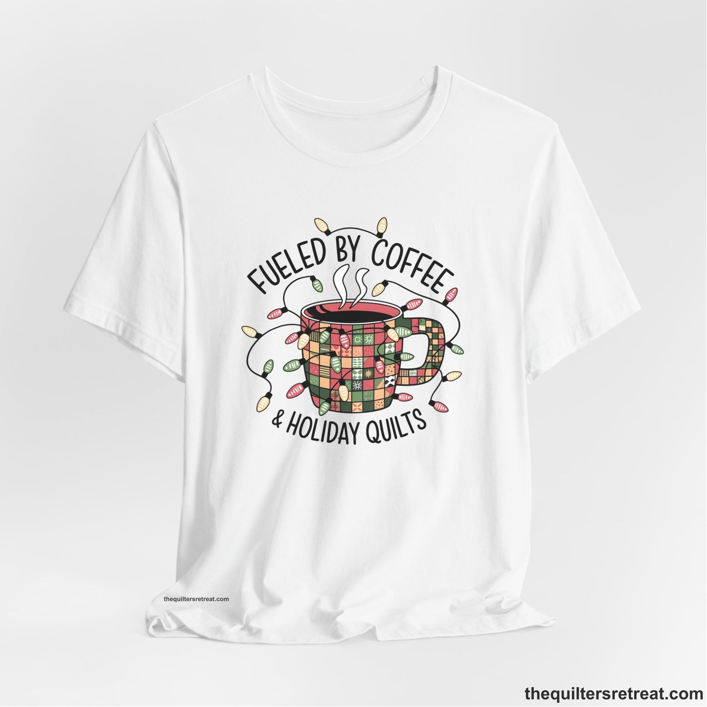 A White Short Sleeve T-Shirt with a patchwork coffee mug with colorful lights and subtle "Fueled by Coffee" text in festive style