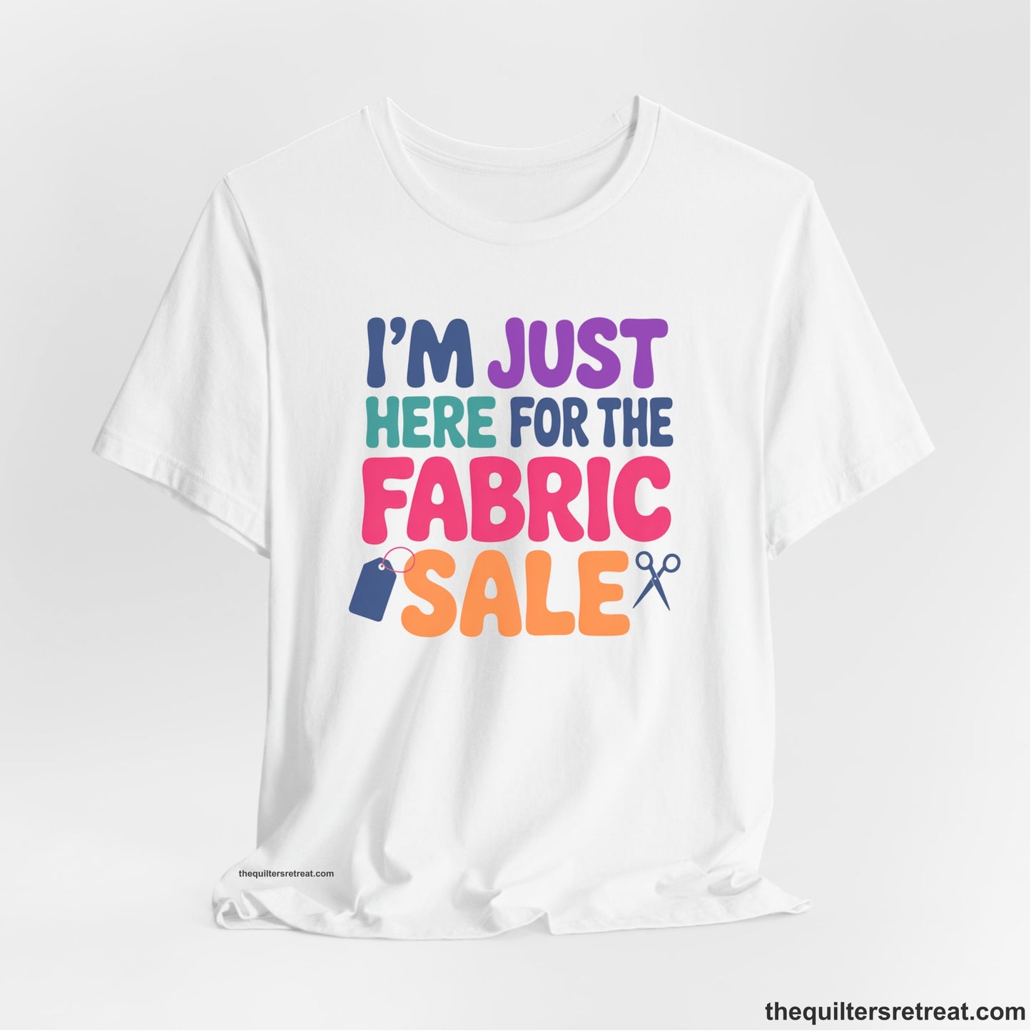A White Short Sleeve T-Shirt with a playful "I'm Just Here for the Fabric Sale" text with colorful letters and sewing icons