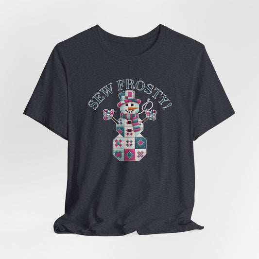A Heather Navy christmas quilting t-shirt featuring cute snowman made of patchwork quilt blocks with the phrase "Sew Frosty" above, holding a needle to highlight the quilting theme.