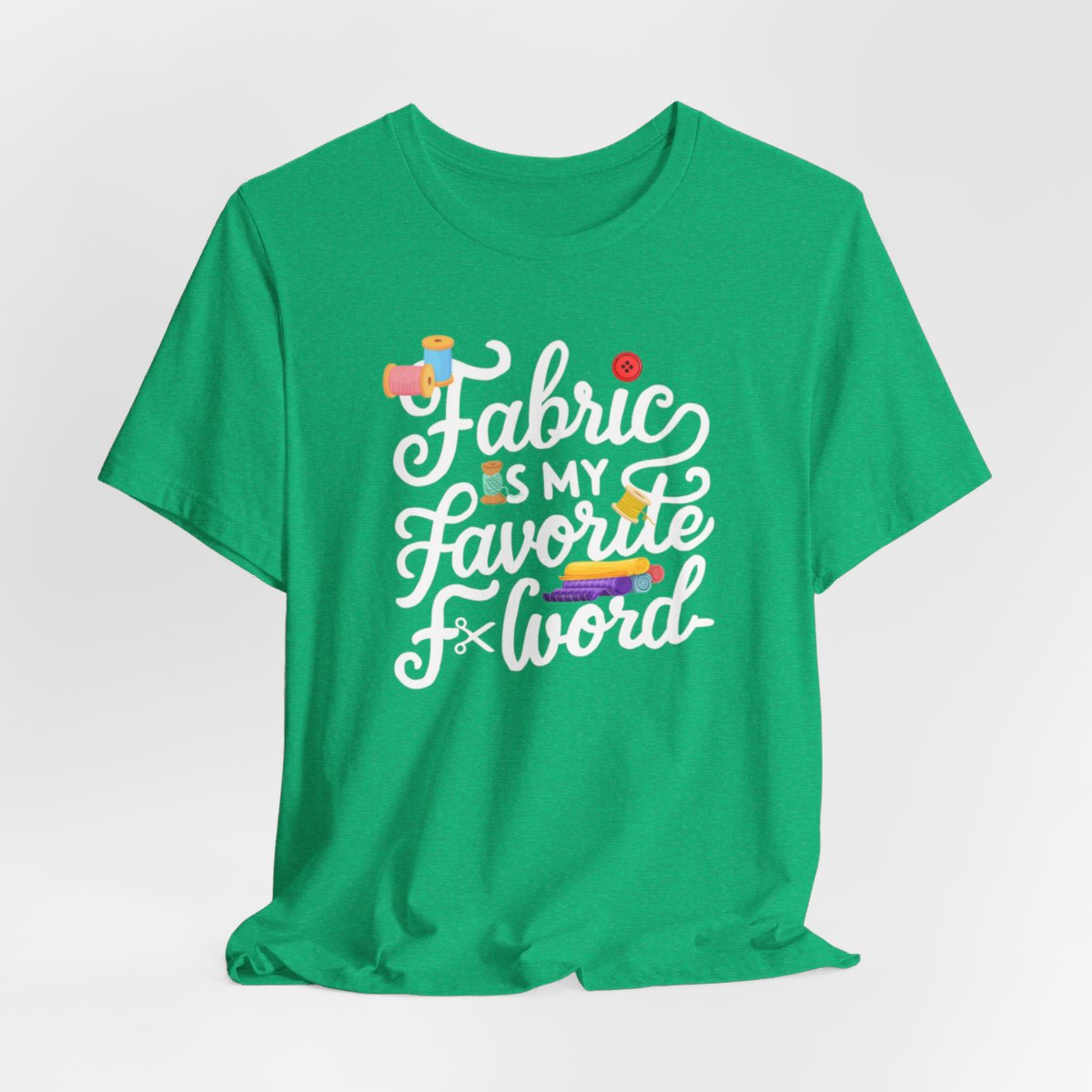 A Heather Kelly T-Shirt with the phrase Fabric is My Favorite F-Word in a bold font with thread, buttons, and fabric bolts