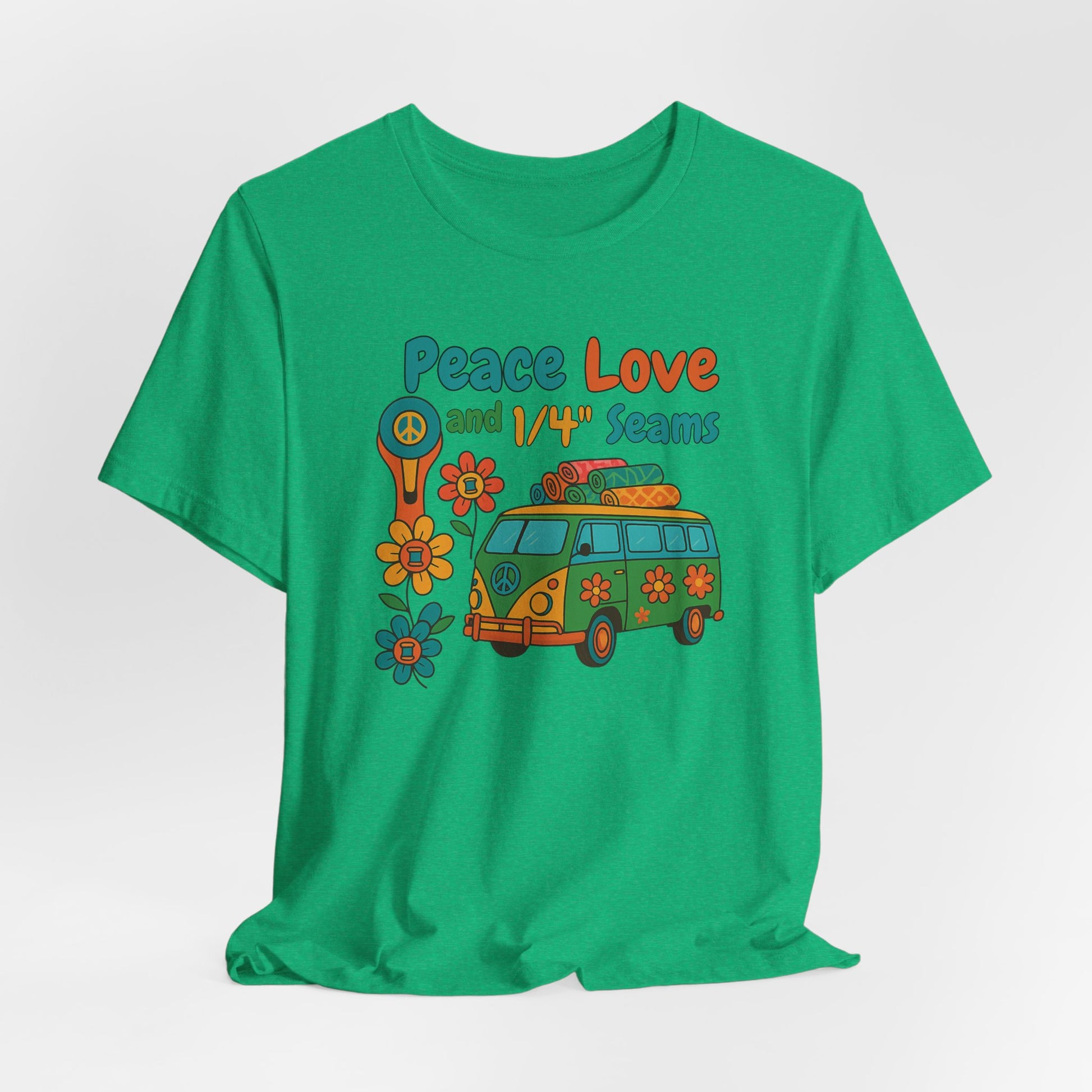 A A Heather Kelly t-shirt with colorful retro design showing a peace sign rotary cutter, patchwork van, and text “Peace Love and 1/4" Seams.” Surrounded by flowers made of thread spools. Fun vintage-style quilting shirt.