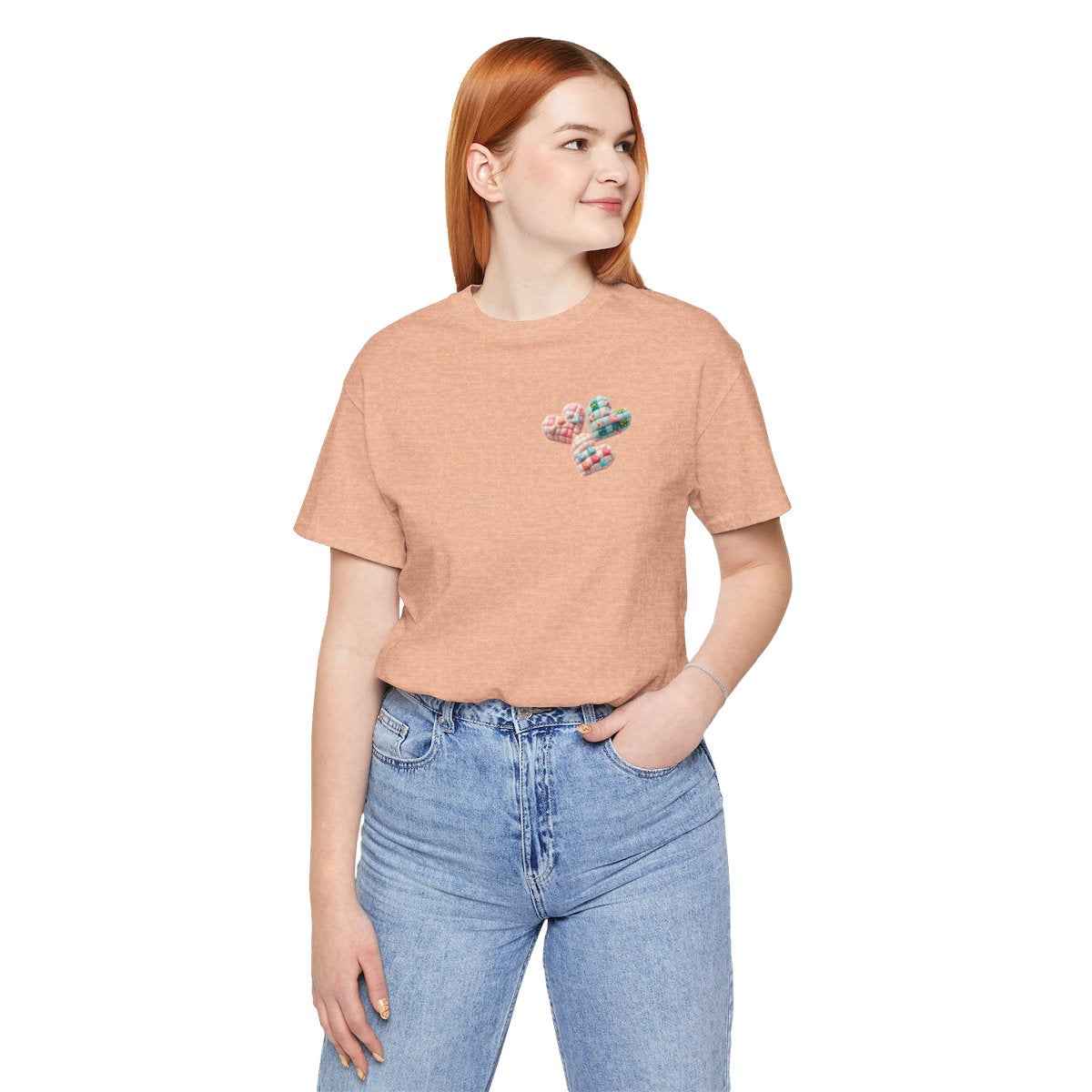 A Heather Peach Tshirt featuring Three heart-shaped quilted designs arranged together. Each heart features different quilting patterns and textures, including patchwork, floral prints, and tiny embroidered hearts. The hearts are in pastel shades of pink and blue, with white accents.