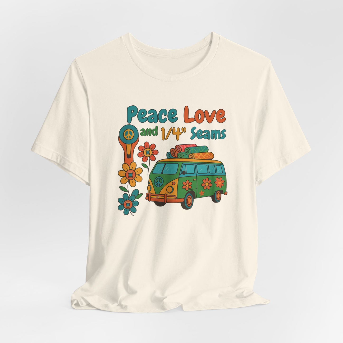 A A Natural t-shirt with colorful retro design showing a peace sign rotary cutter, patchwork van, and text “Peace Love and 1/4" Seams.” Surrounded by flowers made of thread spools. Fun vintage-style quilting shirt.