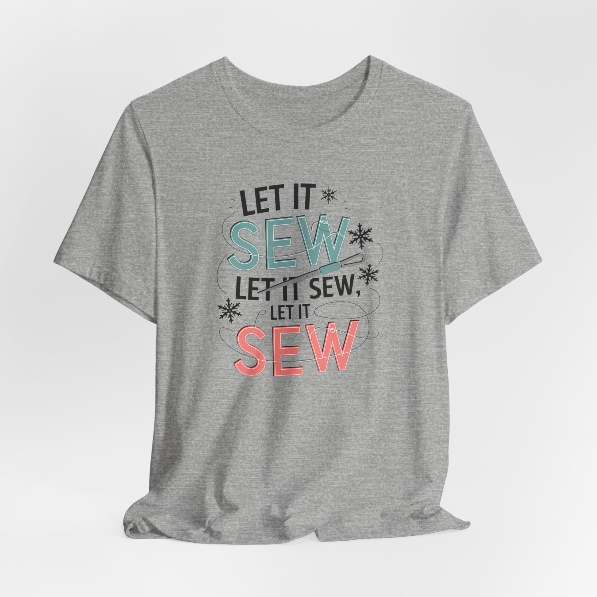 An Athletic Heather christmas quilting t-shirt featuring the phrase "Let it Sew, Let it Sew, Let it Sew" featuring a needle and thread weaving through the letters, accented by snowflakes to bring out the holiday theme.