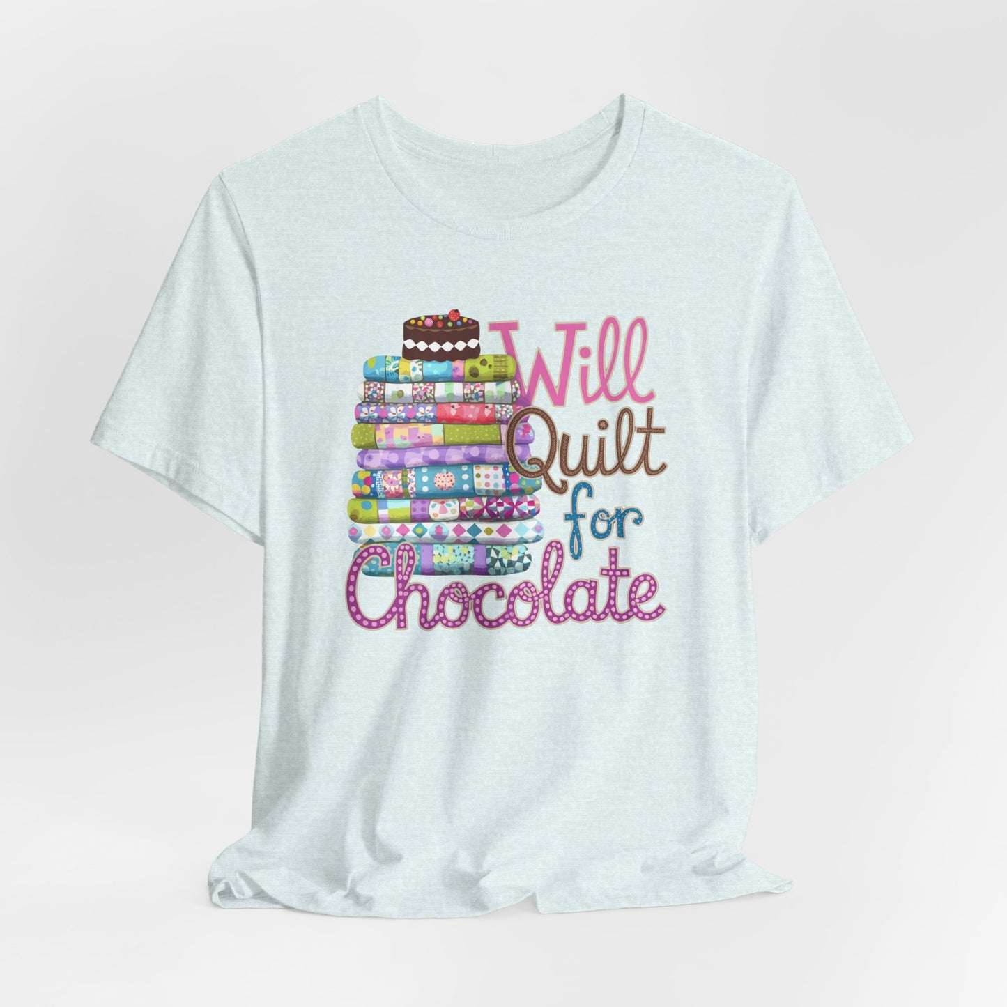 A Heather Ice Blue t-shirt featuring a whimsical design of a colorful stack of quilts topped with a chocolate cake and the phrase 'Will Quilt for Chocolate,' perfect for quilters who love sweets.