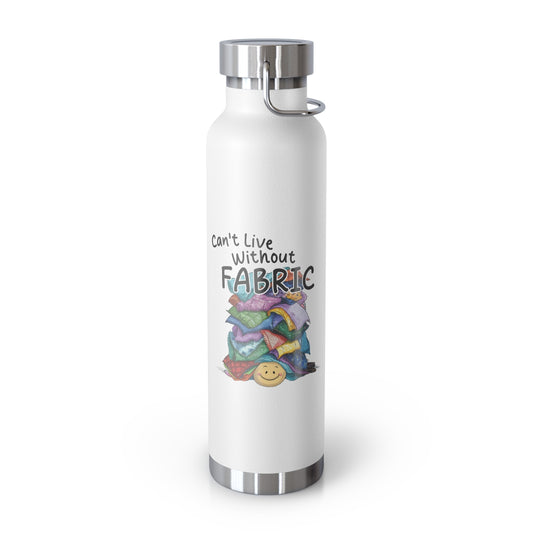 A White funny quilting-inspired Insulated Bottle with a cute illustration showing a happy face under a pile of multicolored fabric pieces. Hand-lettered text says "Can't Live Without Fabric". The fabrics display various patterns and textures.