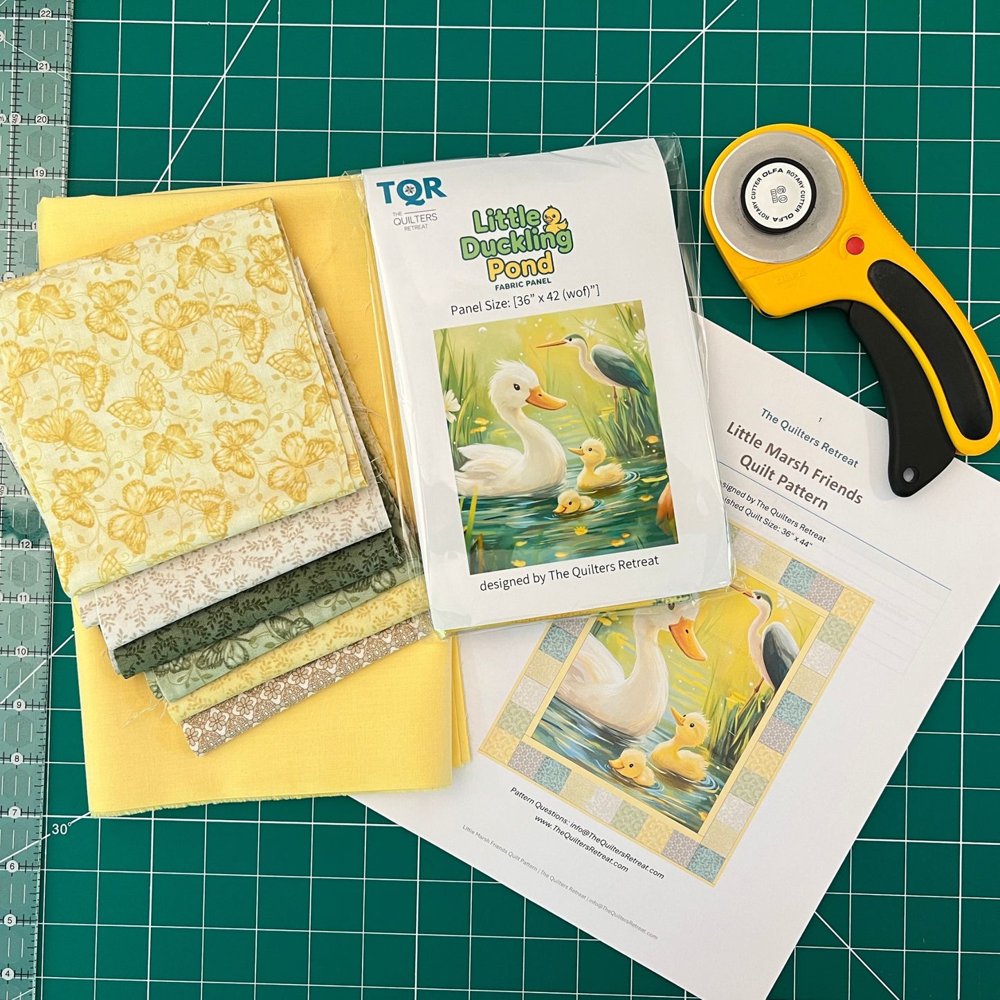 Little Marsh Friends baby quilt kit contents — Little Duckling Pond panel, pattern, fabrics and rotary cutter