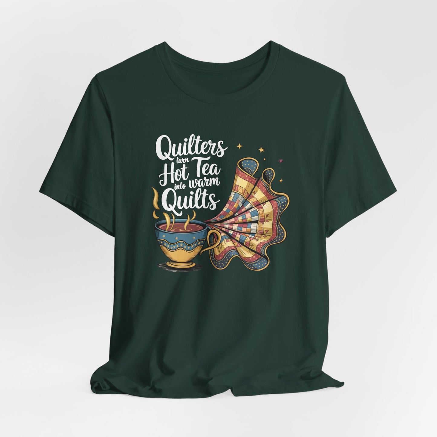 A Forest t-shirt with a whimsical design of a teacup transforming into a patchwork quilt, accompanied by the phrase 'Quilters turn hot tea into warm quilts.' Ideal for quilters and tea lovers
