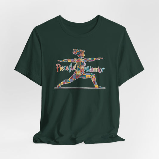 A Forest Tee featuring a colorful patchwork silhouette of woman in yoga warrior pose. Text reads "Pieceful Warrior" in multicolored lettering.