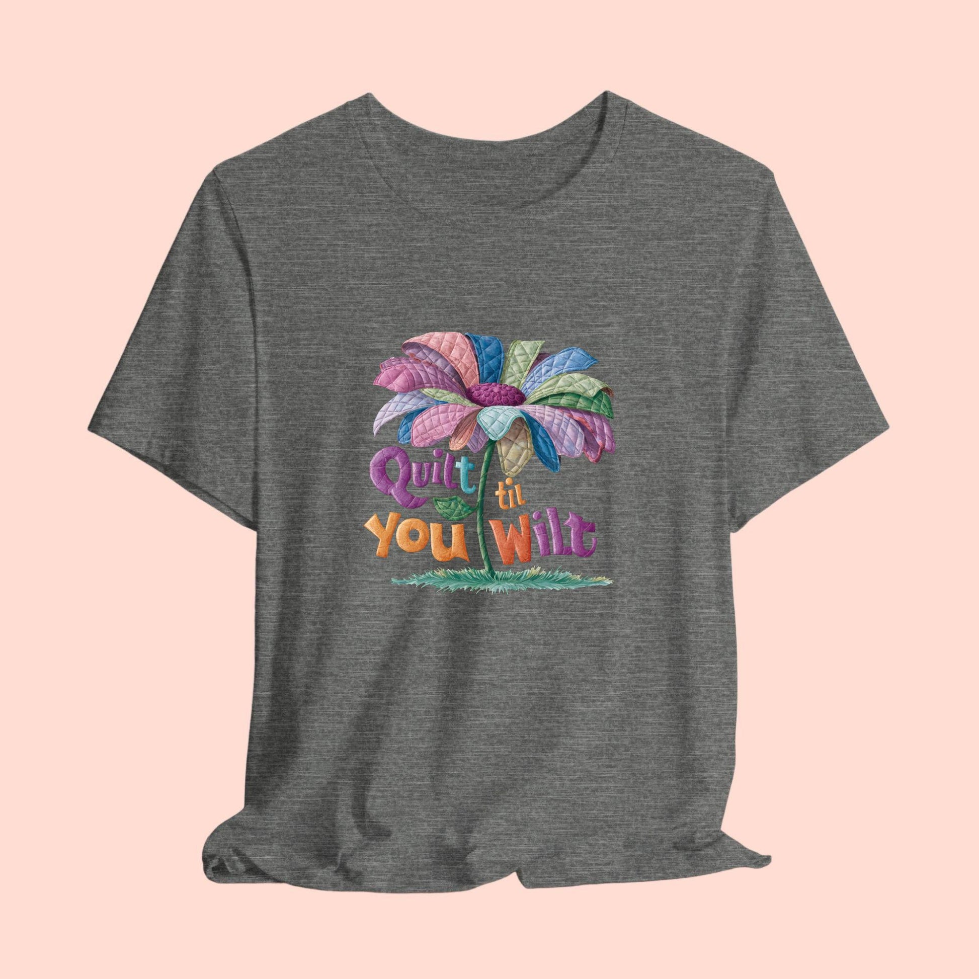 A funny quilting T-Shirt with the phrase Quilt 'Till You Wilt showing a cheerful, but slightly wilted quilted flower design