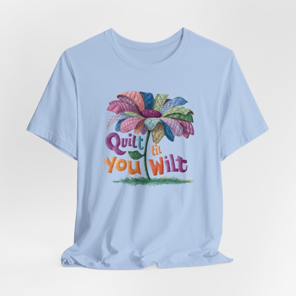 A Baby Blue funny quilting T-Shirt with the phrase Quilt 'Till You Wilt showing a cheerful, but slightly wilted quilted flower design