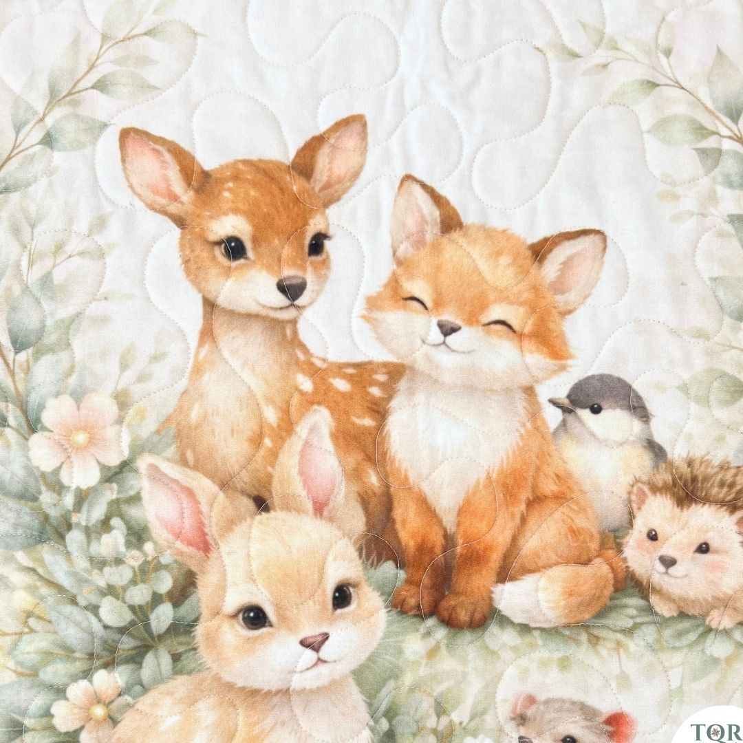 Close-up of the woodland friends baby quilt panel — quilted woodland animals