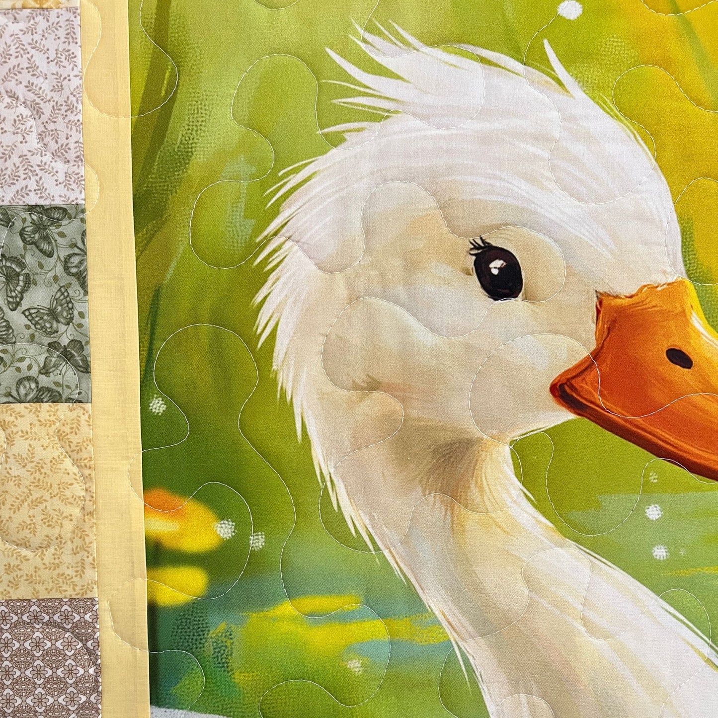 Close-up of the Little Marsh Friends panel — a quilted white mother duck on the pond