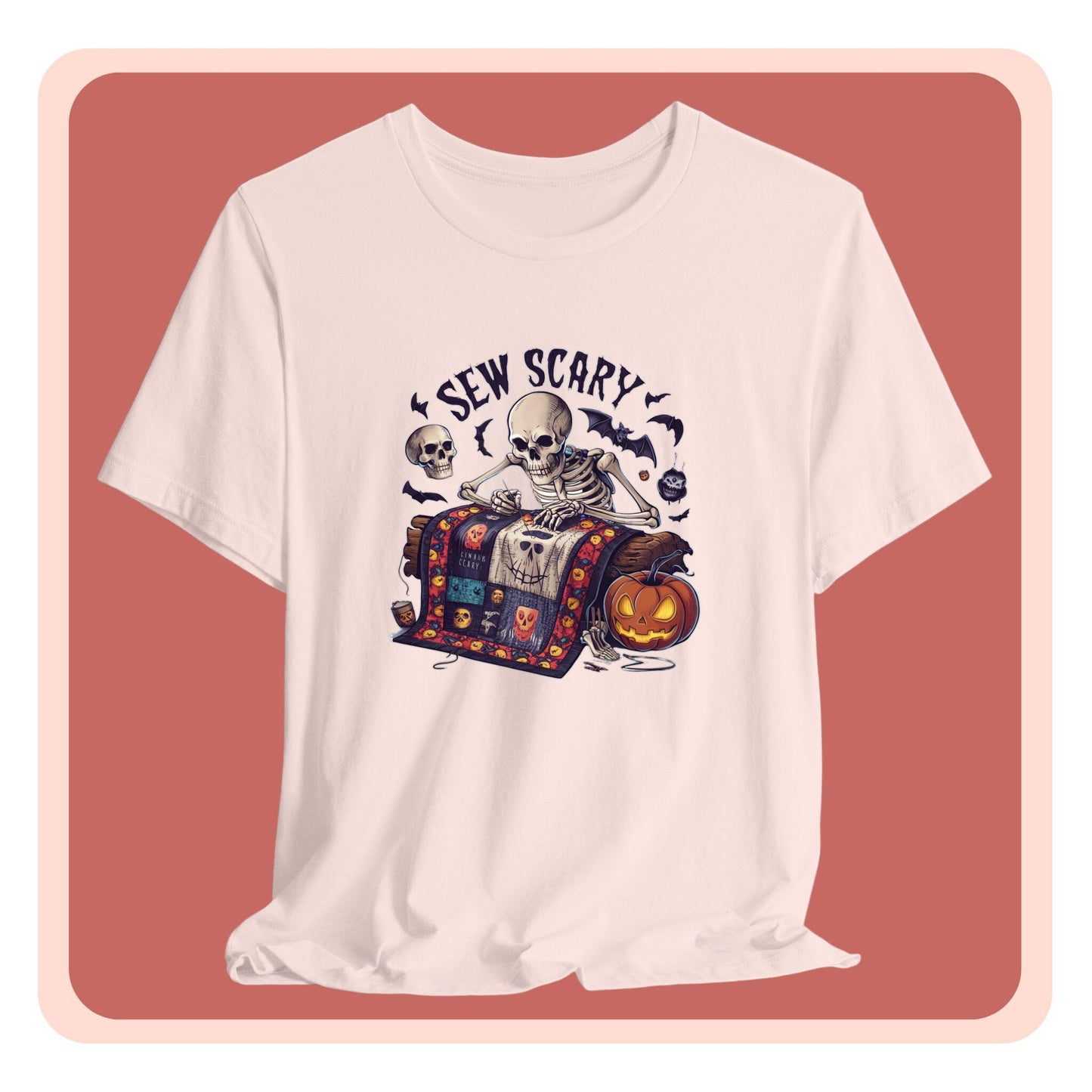 A Halloween Quilting T-Shirt featuring a skeleton sewing Halloween quilt. Colorful patchwork with spooky motifs. Bats and pumpkins surround skeleton. Text reads "Sew Scary". Ideal for quilters who love Halloween.