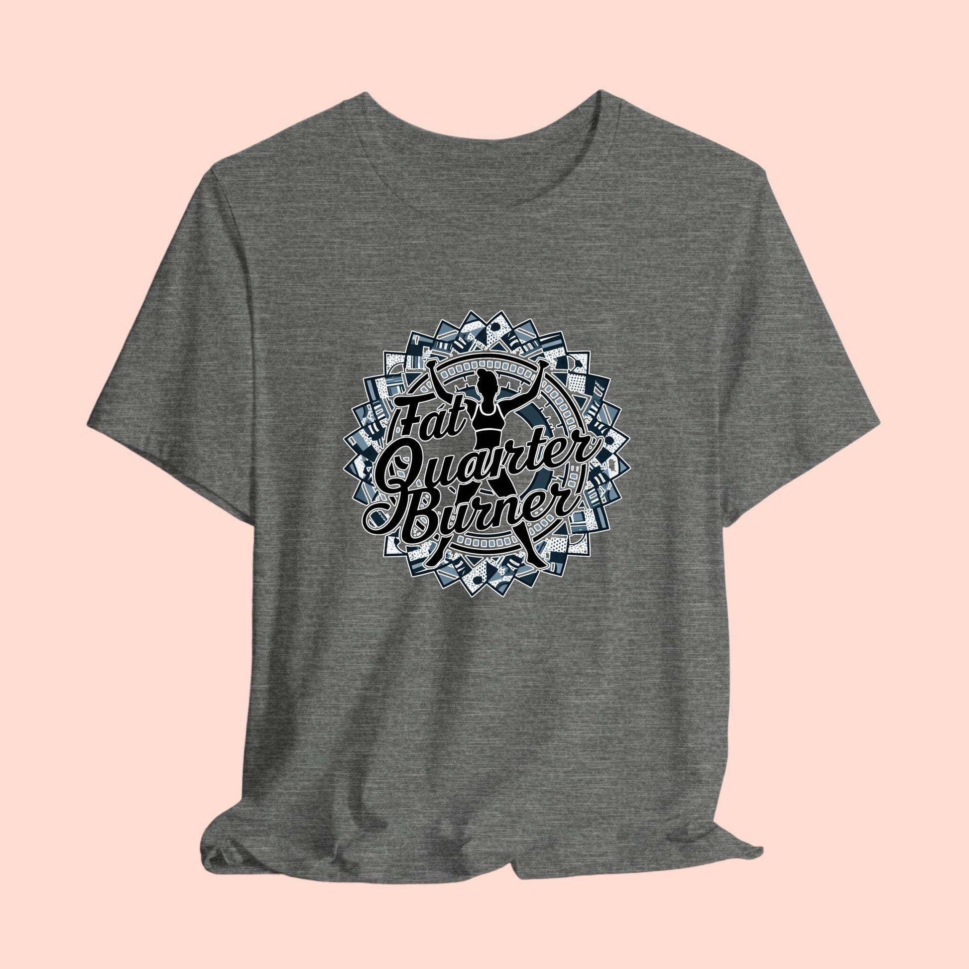 A T-Shirt featuring a patchwork border surrounding silhouette of woman lifting weights. Text reads "Fat Quarter Burner" in bold script.