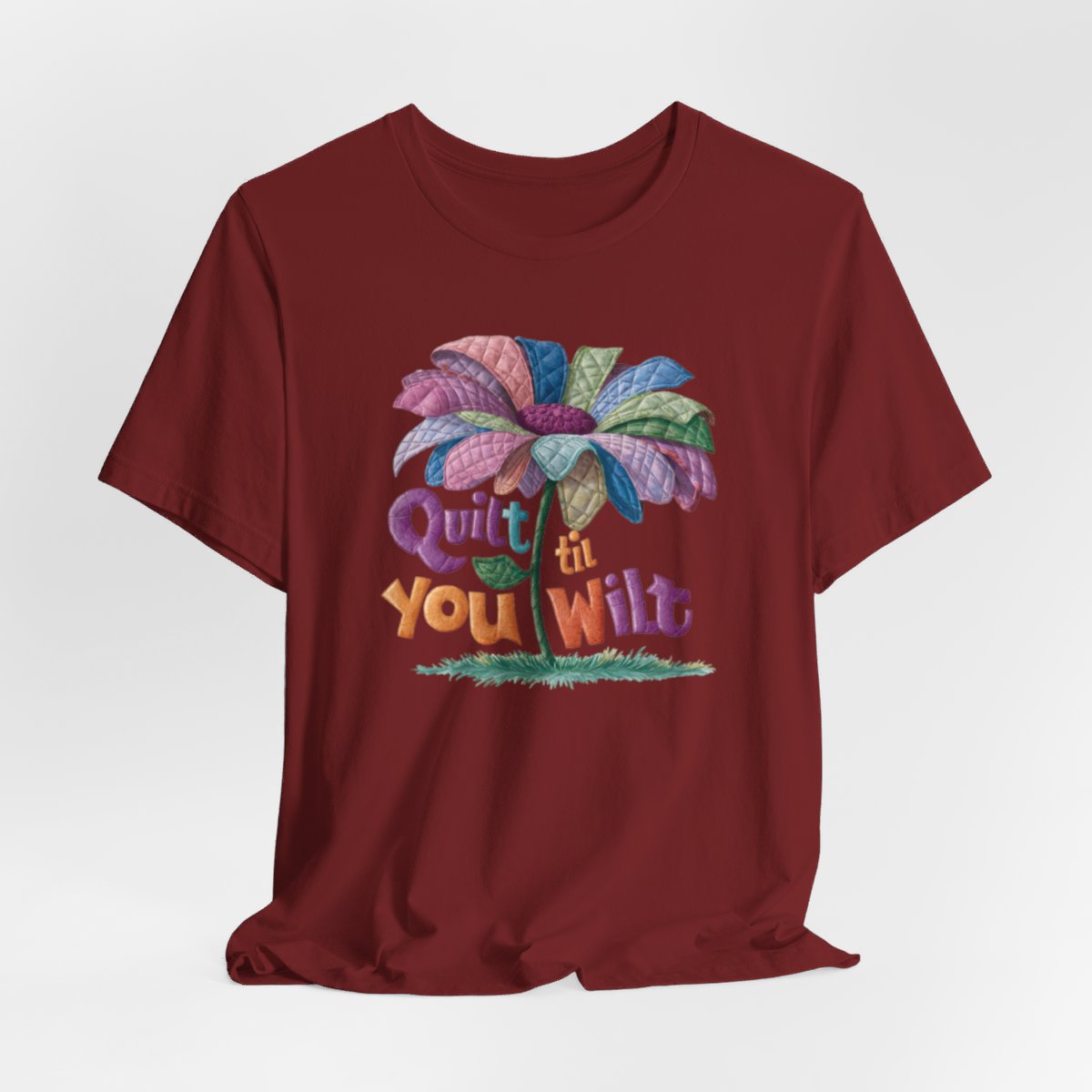 A Cardinal funny quilting T-Shirt with the phrase Quilt 'Till You Wilt showing a cheerful, but slightly wilted quilted flower design