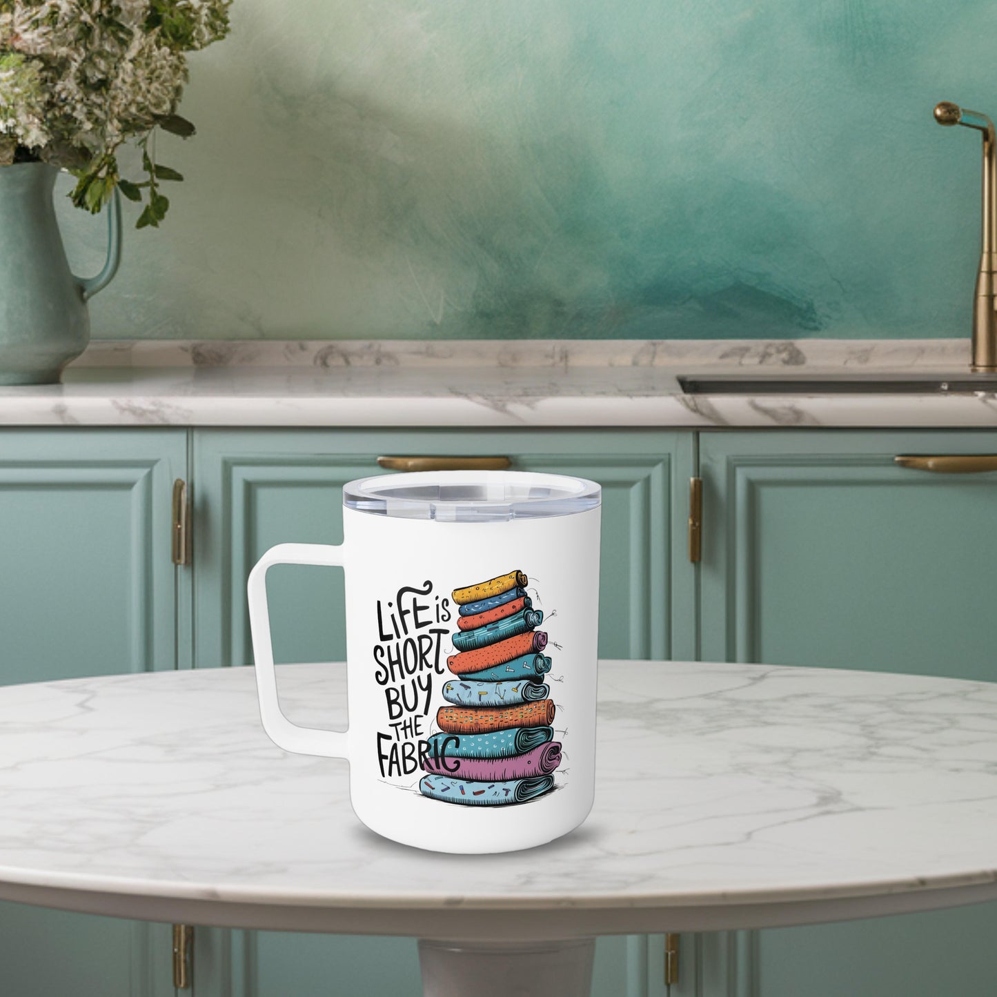 A funny quilting-inspired Insulated Mug with the phrase Life is Short, Buy the Fabric with the label 'Life is Short, Buy the Fabric' next to a graphic of a fun pile of fabric