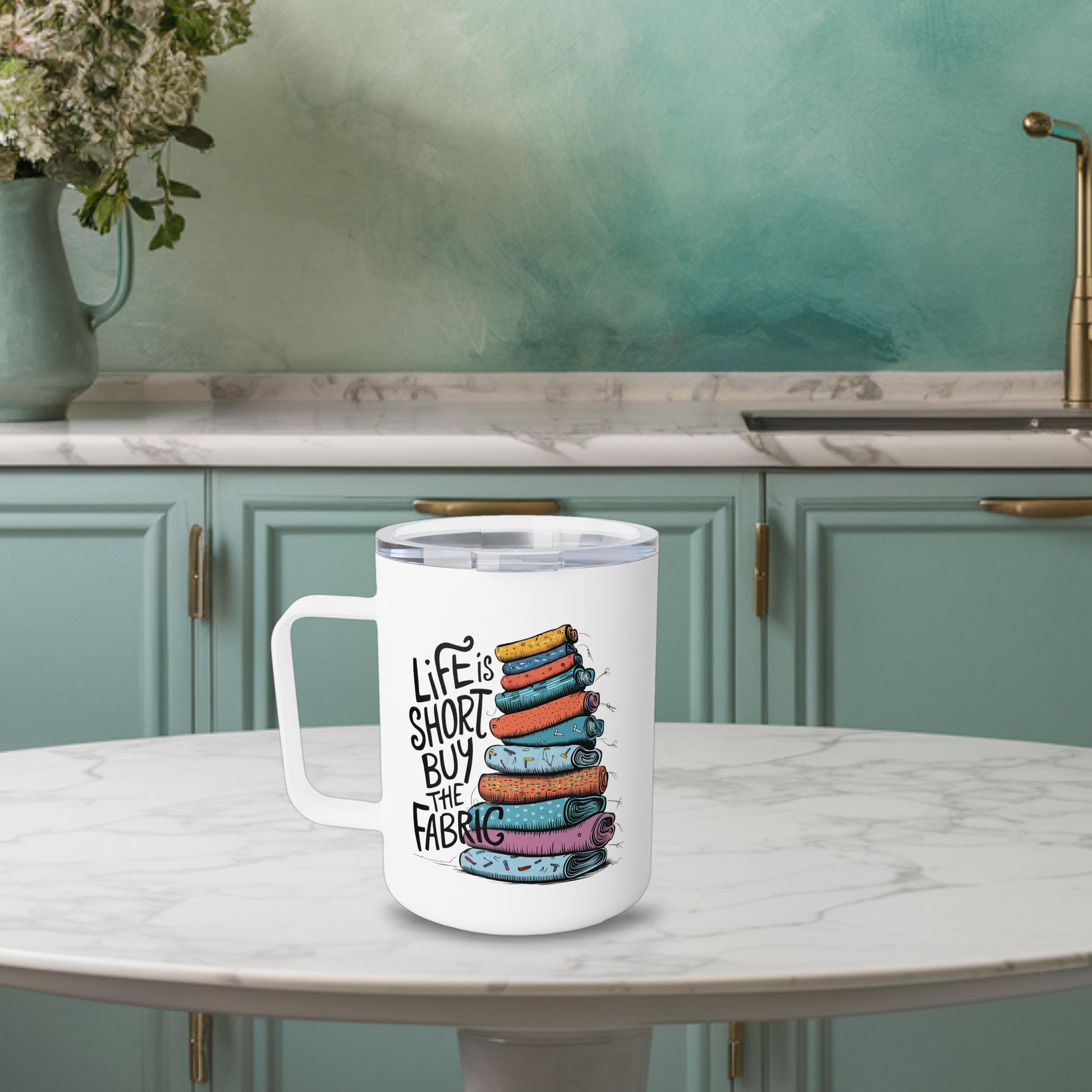 A funny quilting-inspired Insulated Mug with the phrase Life is Short, Buy the Fabric with the label 'Life is Short, Buy the Fabric' next to a graphic of a fun pile of fabric