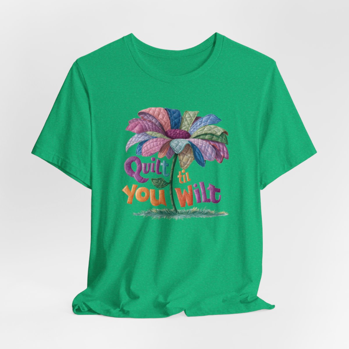 A Heather Kelly funny quilting T-Shirt with the phrase Quilt 'Till You Wilt showing a cheerful, but slightly wilted quilted flower design