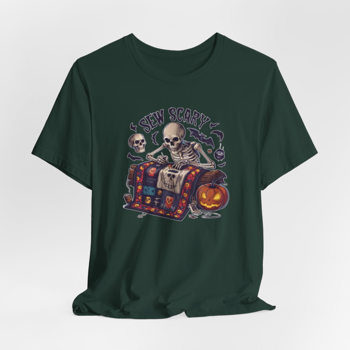 A Forest Halloween Quilting T-Shirt featuring a skeleton sewing Halloween quilt. Colorful patchwork with spooky motifs. Bats and pumpkins surround skeleton. Text reads "Sew Scary". Ideal for quilters who love Halloween.