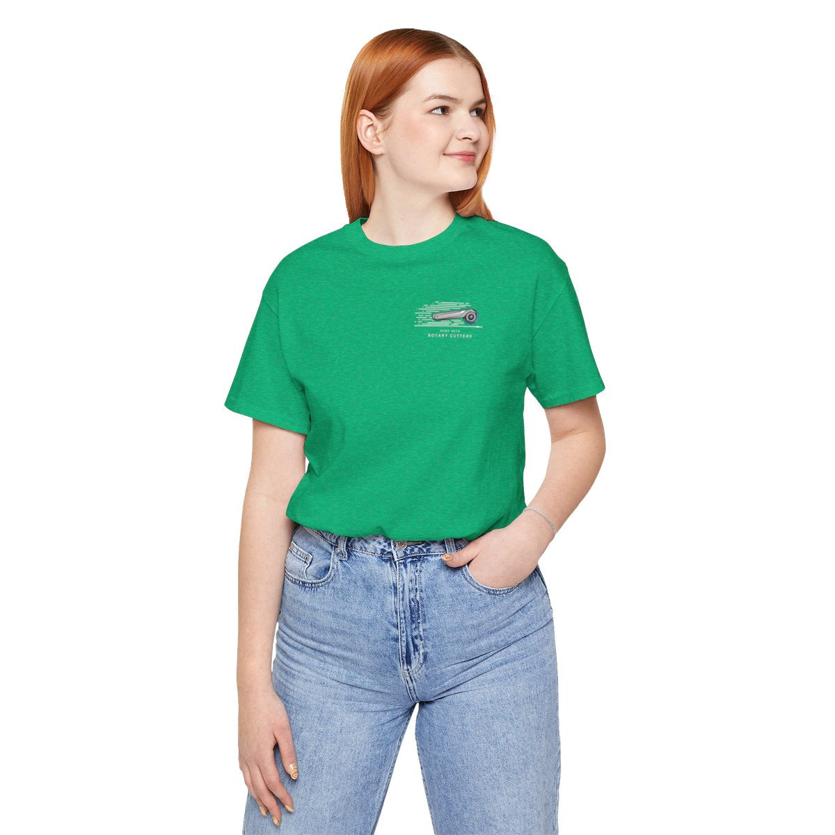 A Heather Kelly T-shirt featuring minimalist graphic of a sleek rotary cutter in motion with speed lines. Text below reads "RUNS WITH ROTARY CUTTERS" in a modern font.