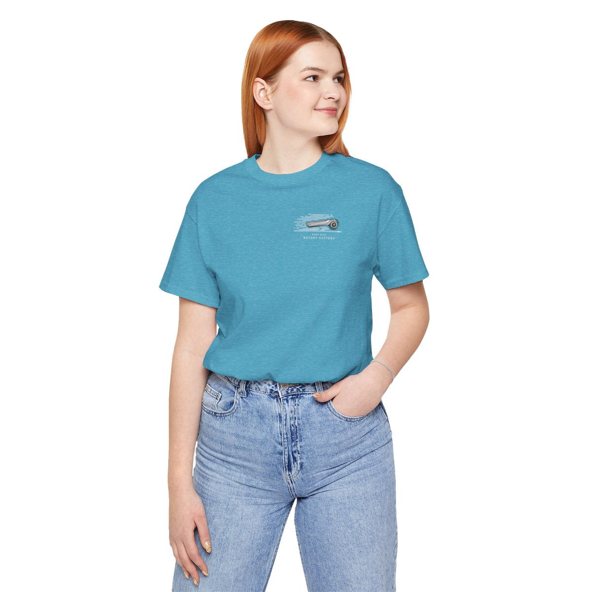 A Heather Aqua T-shirt featuring minimalist graphic of a sleek rotary cutter in motion with speed lines. Text below reads "RUNS WITH ROTARY CUTTERS" in a modern font.