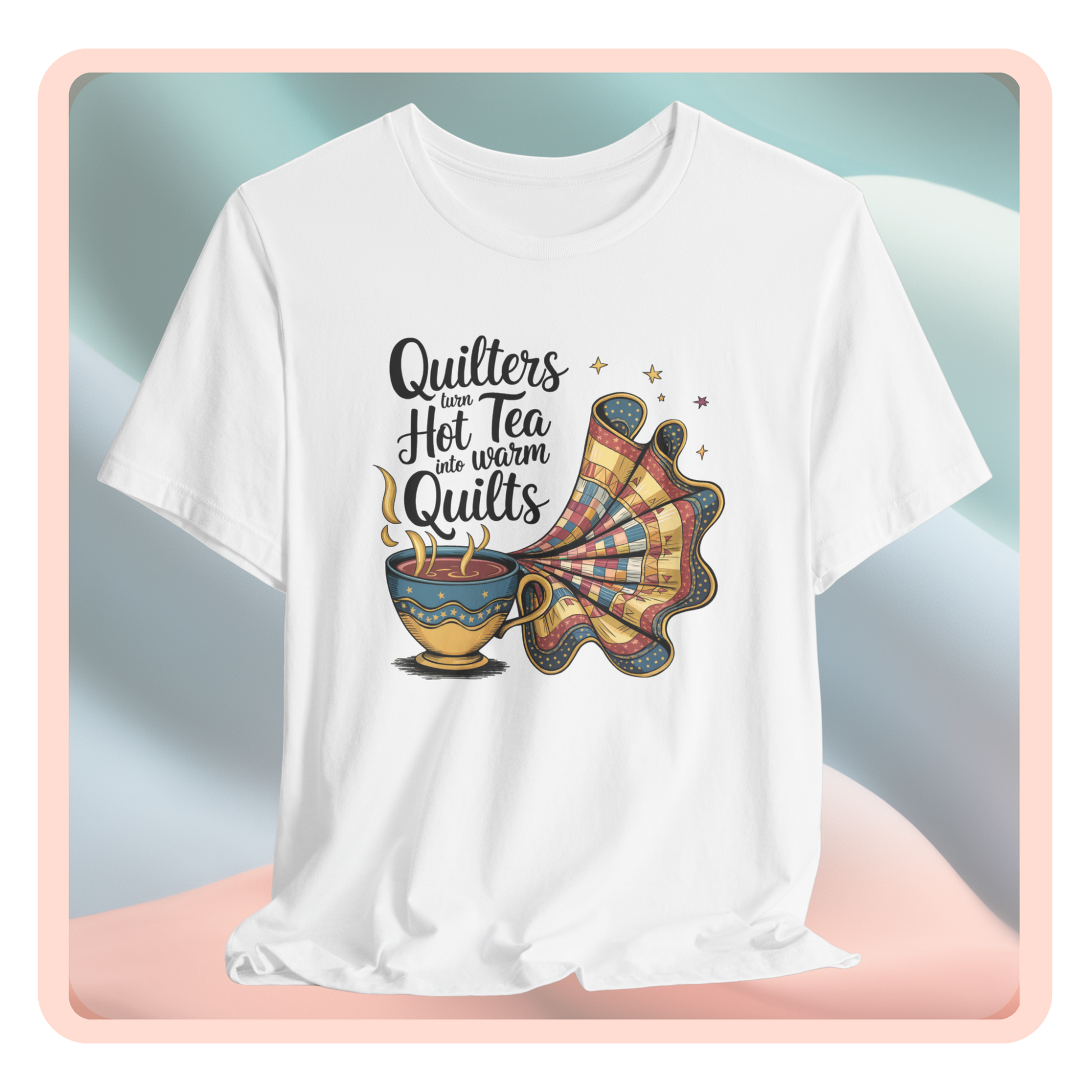 A t-shirt with a whimsical design of a teacup transforming into a patchwork quilt, accompanied by the phrase 'Quilters turn hot tea into warm quilts.' Ideal for quilters and tea lovers