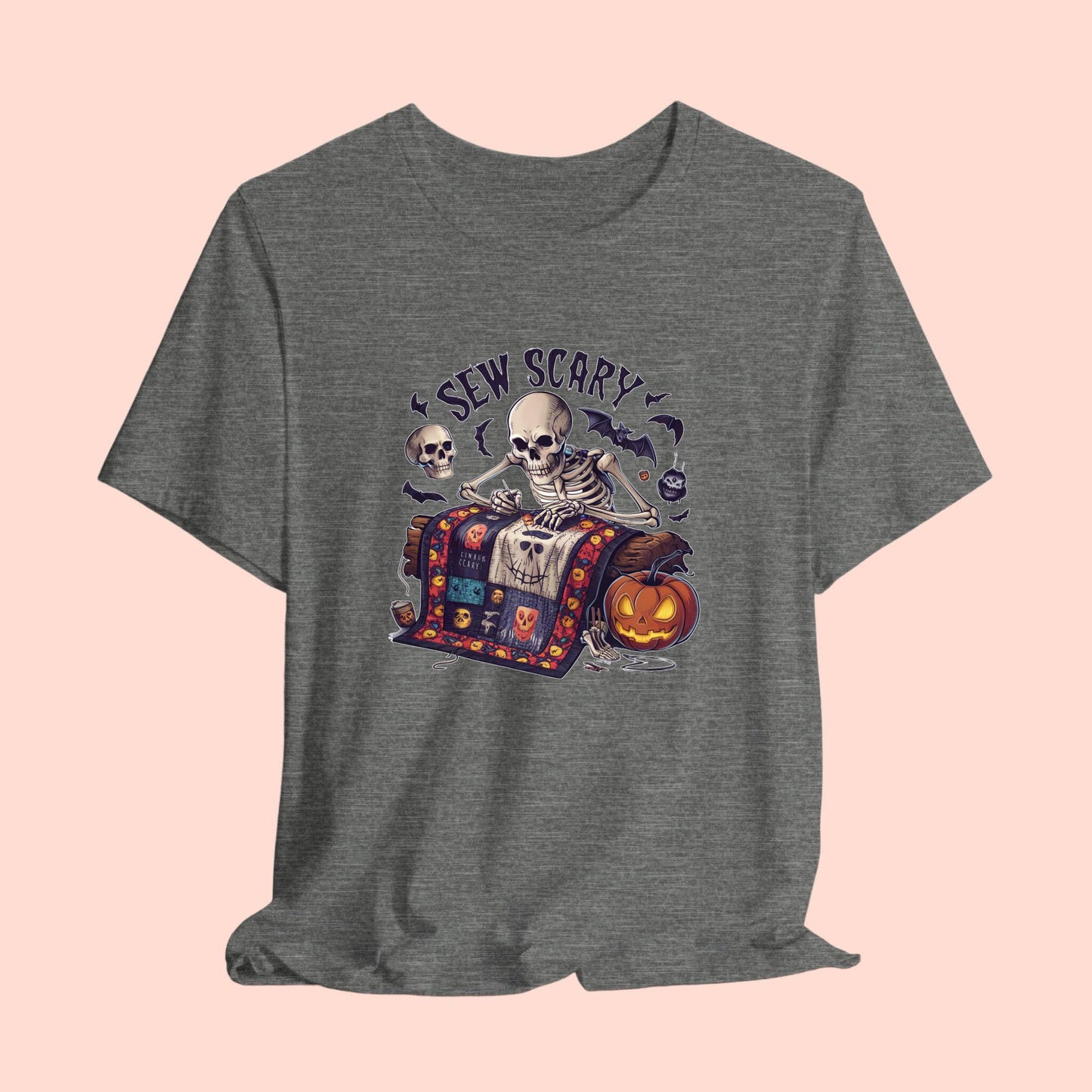 A Halloween Quilting T-Shirt featuring a skeleton sewing Halloween quilt. Colorful patchwork with spooky motifs. Bats and pumpkins surround skeleton. Text reads "Sew Scary". Ideal for quilters who love Halloween.