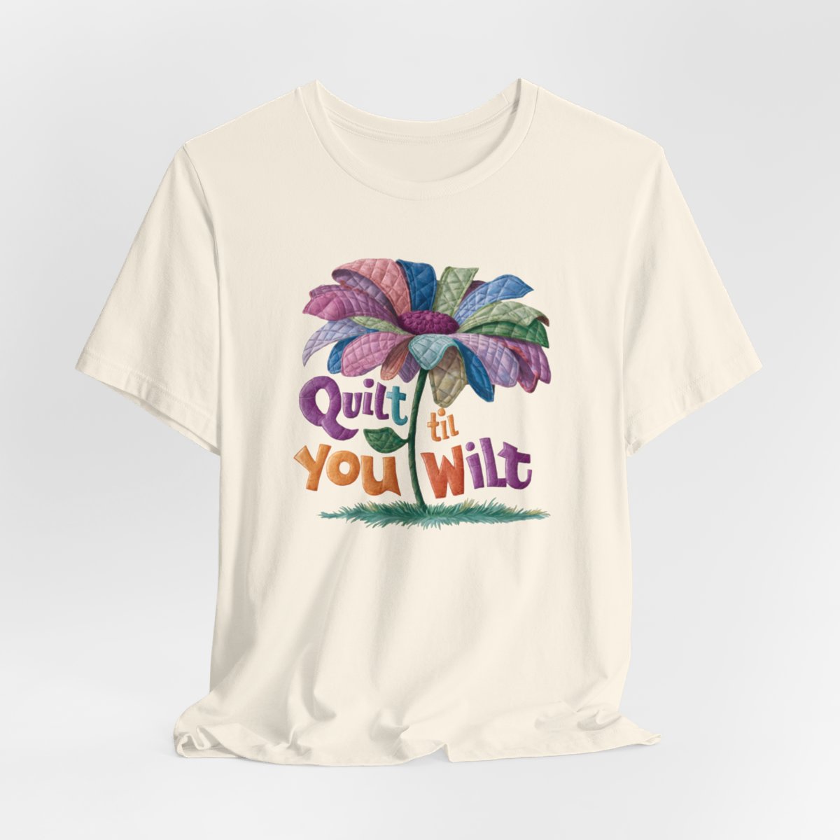 A Natural funny quilting T-Shirt with the phrase Quilt 'Till You Wilt showing a cheerful, but slightly wilted quilted flower design