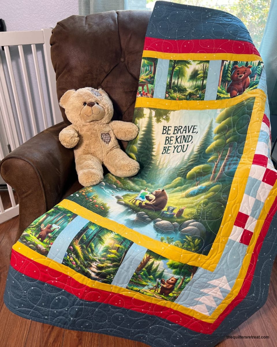 Be Kind Bear panel sewn into a navy and red bordered quilt for a child's room