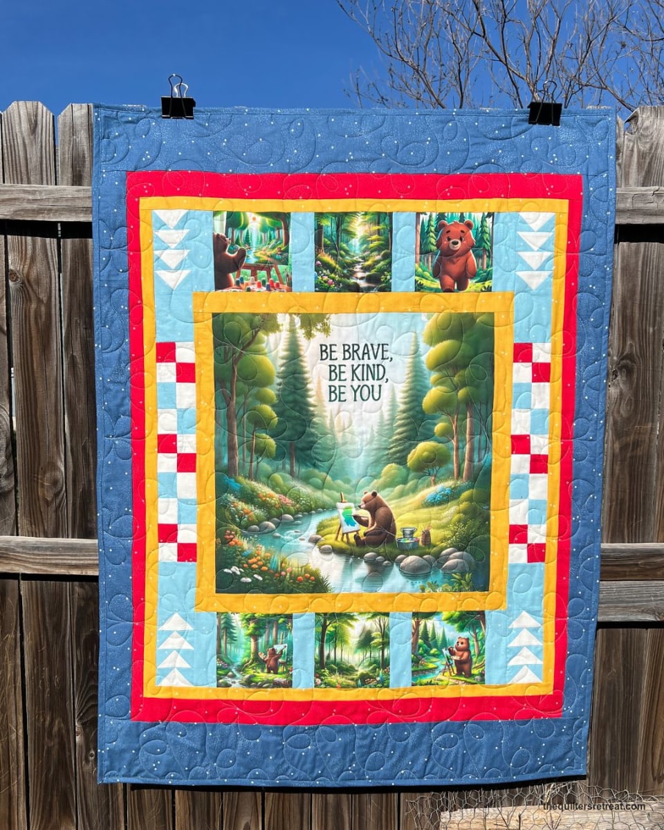 Be Kind Bear panel quilt kit finished in blue — bear vignettes with checkerboard and flying-geese borders