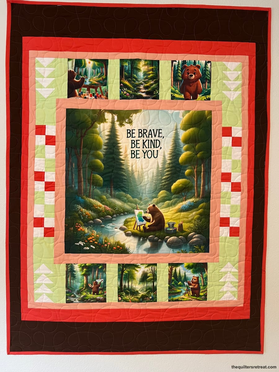 Be Kind Bear quilt kit in brown and coral — bear-painting panel framed by pieced checkerboard borders