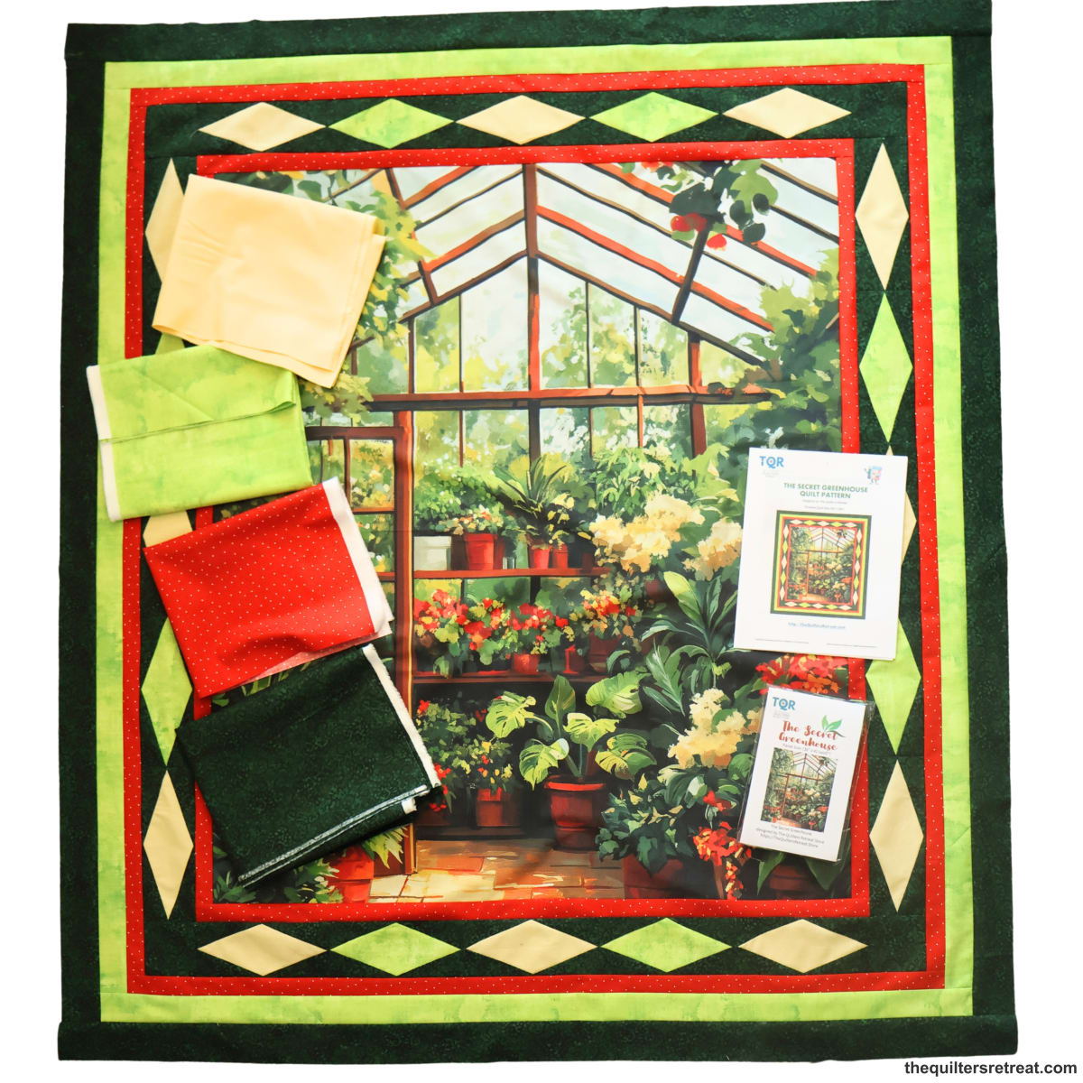 Secret Greenhouse quilt kit contents — greenhouse panel, pattern and coordinating green, red and gold fabrics