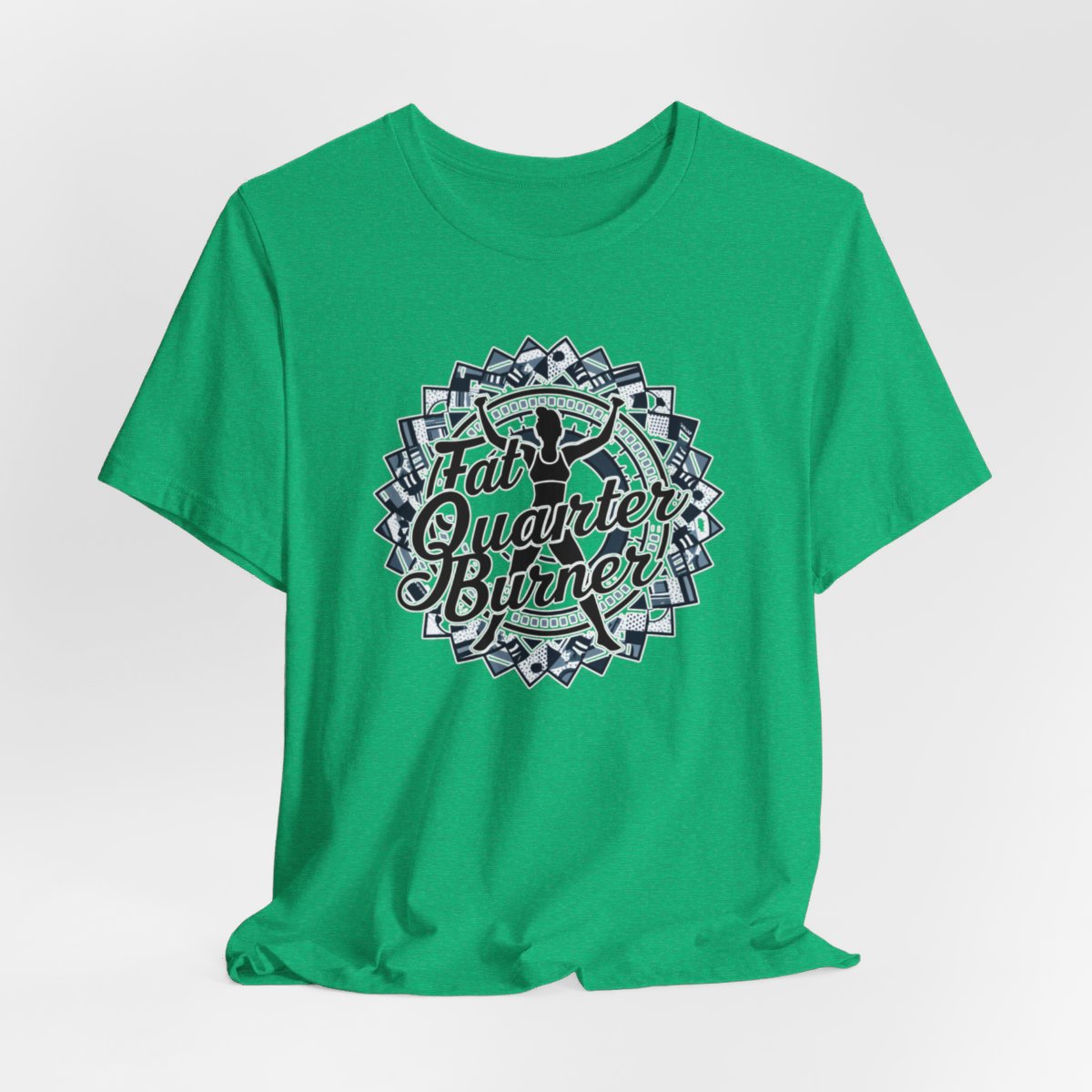 A Heather Kelly T-Shirt featuring a patchwork border surrounding silhouette of woman lifting weights. Text reads "Fat Quarter Burner" in bold script.
