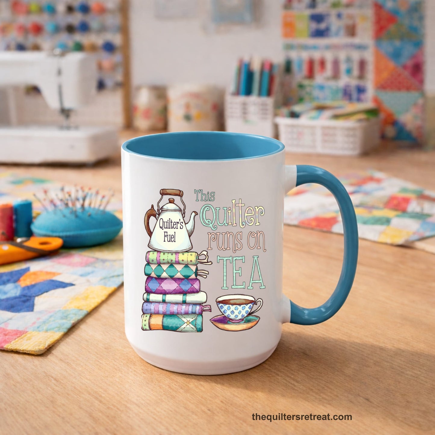 A Self-Fulfilled Ceramic Accent Mug with a stack of colorful quilts with teapot and cup, whimsical "This Quilter Runs on Tea" text