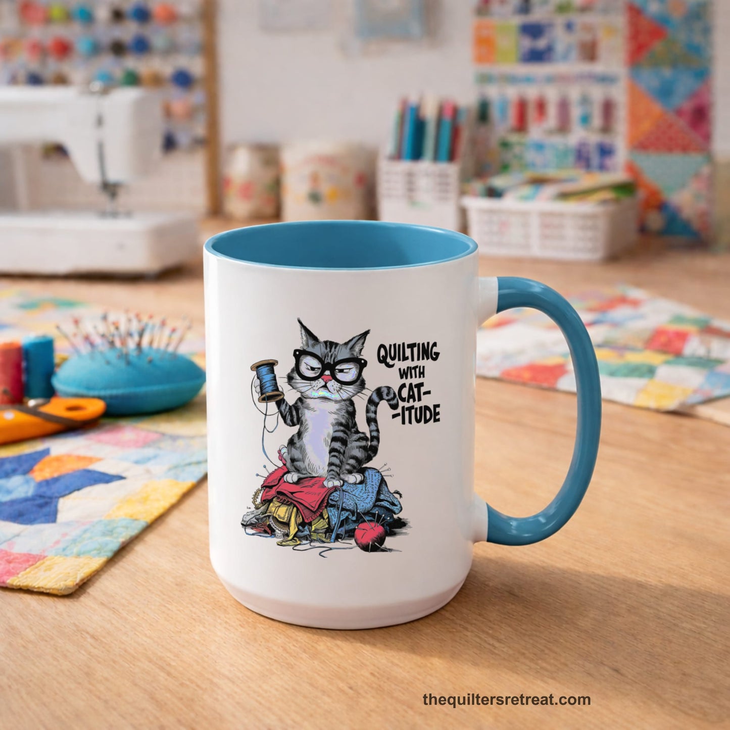 A Light Blue Accent Ceramic Mug featuring Quilting with Catitude design with a grumpy cat holding thread spool atop fabric pile