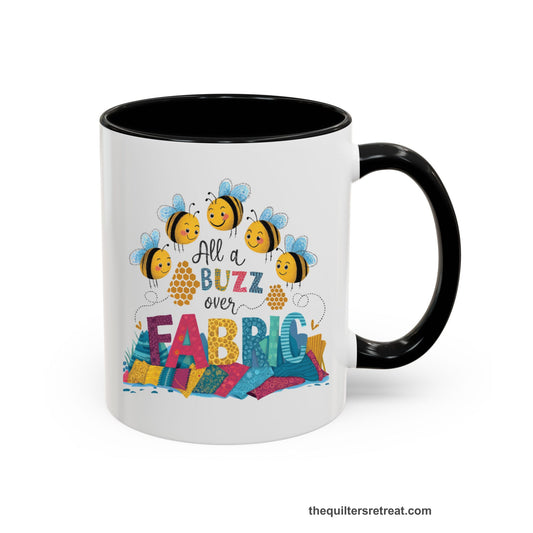 A Black Self-Fulfilled Accent Mug with a playful bees with "All a Buzz over Fabric" text and colorful fabric stacks