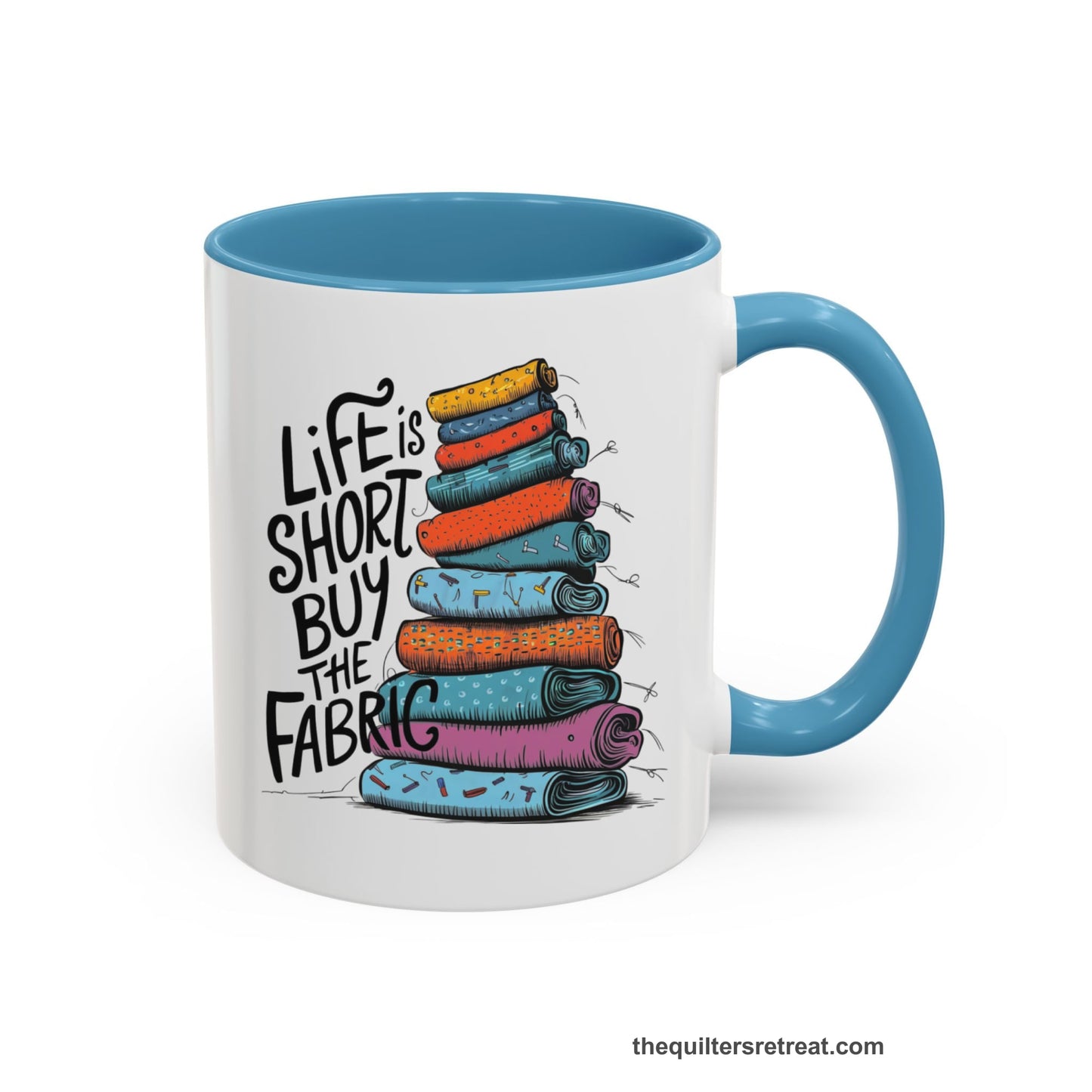 A Light Blue Self-Fulfilled Accent Mug with a illustration of colorful fabric rolls with bold "Life is Short Buy the Fabric" text