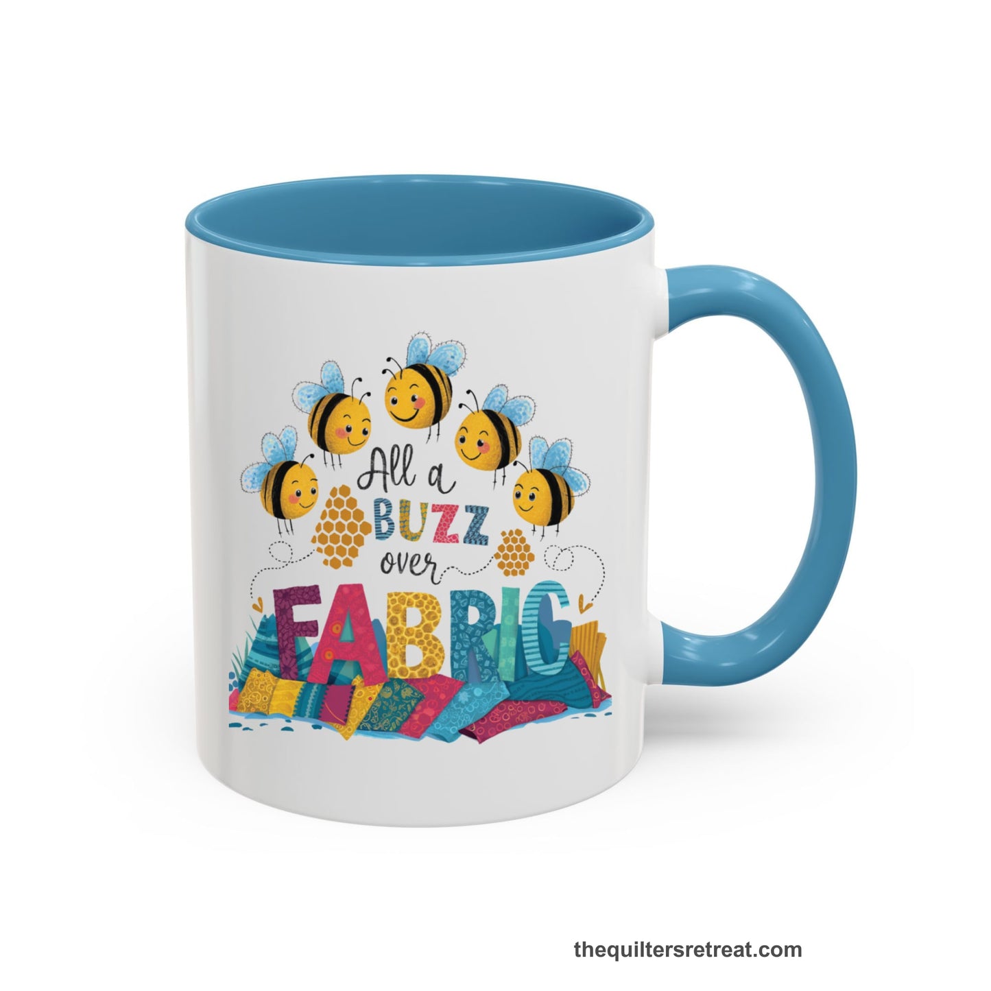 A Light Blue Self-Fulfilled Accent Mug with a playful bees with "All a Buzz over Fabric" text and colorful fabric stacks