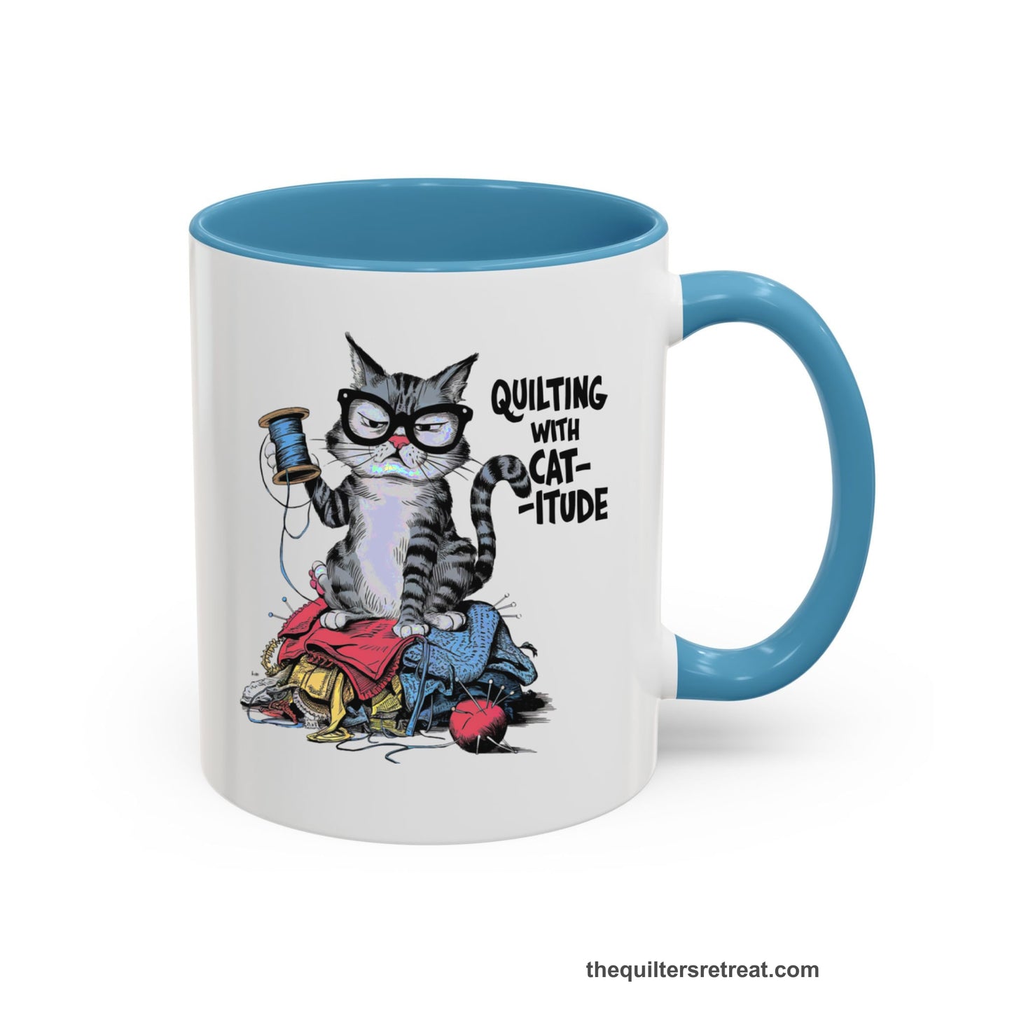 A Light Blue Accent Ceramic Mug featuring Quilting with Catitude design with a grumpy cat holding thread spool atop fabric pile
