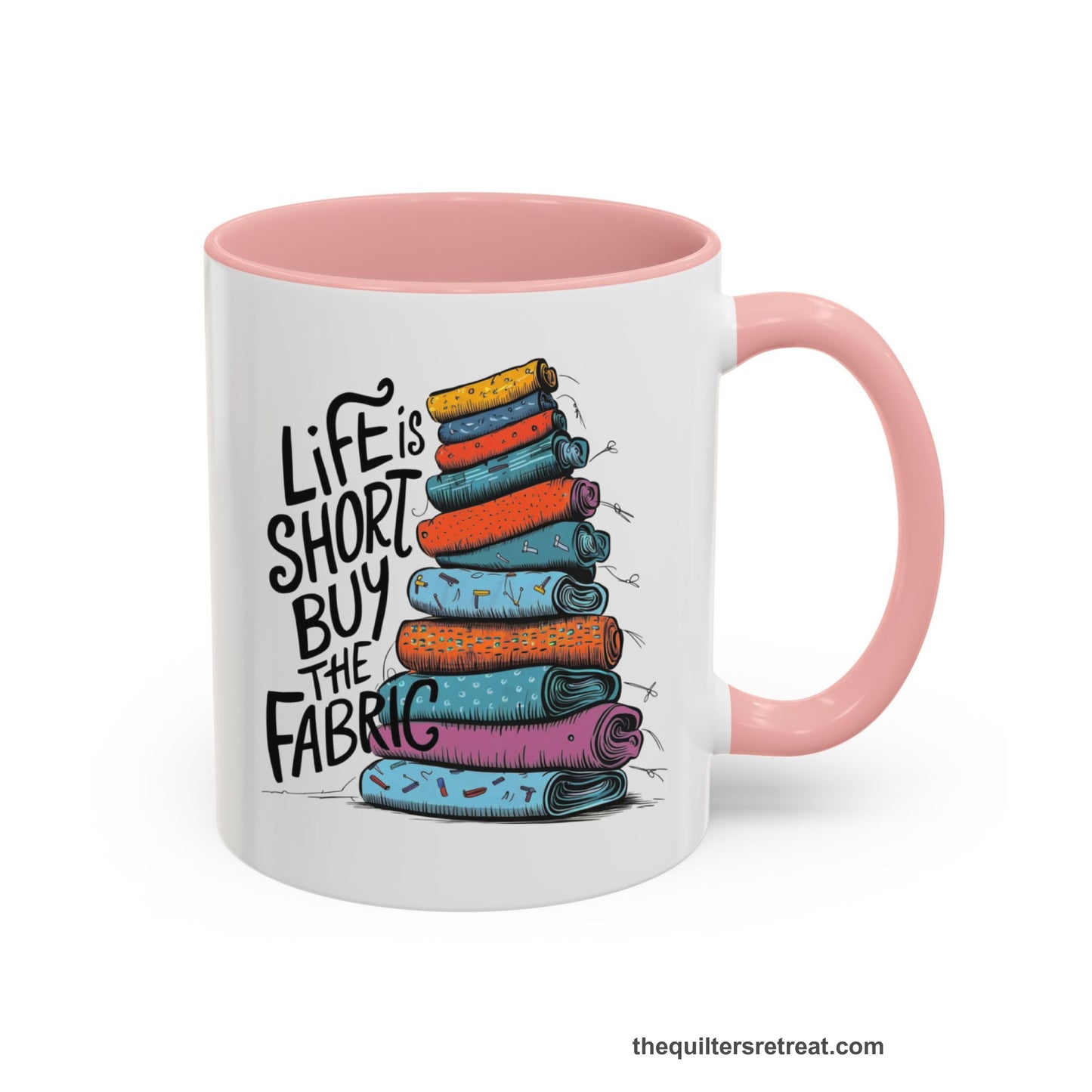 A Pink Self-Fulfilled Accent Mug with a illustration of colorful fabric rolls with bold "Life is Short Buy the Fabric" text