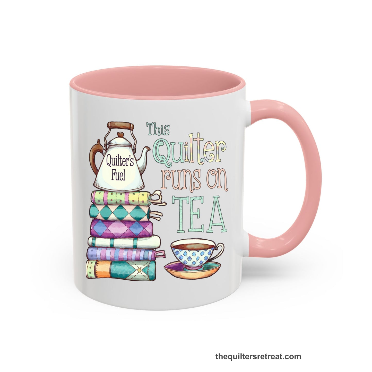 A Pink Self-Fulfilled Ceramic Accent Mug with a stack of colorful quilts with teapot and cup, whimsical "This Quilter Runs on Tea" text