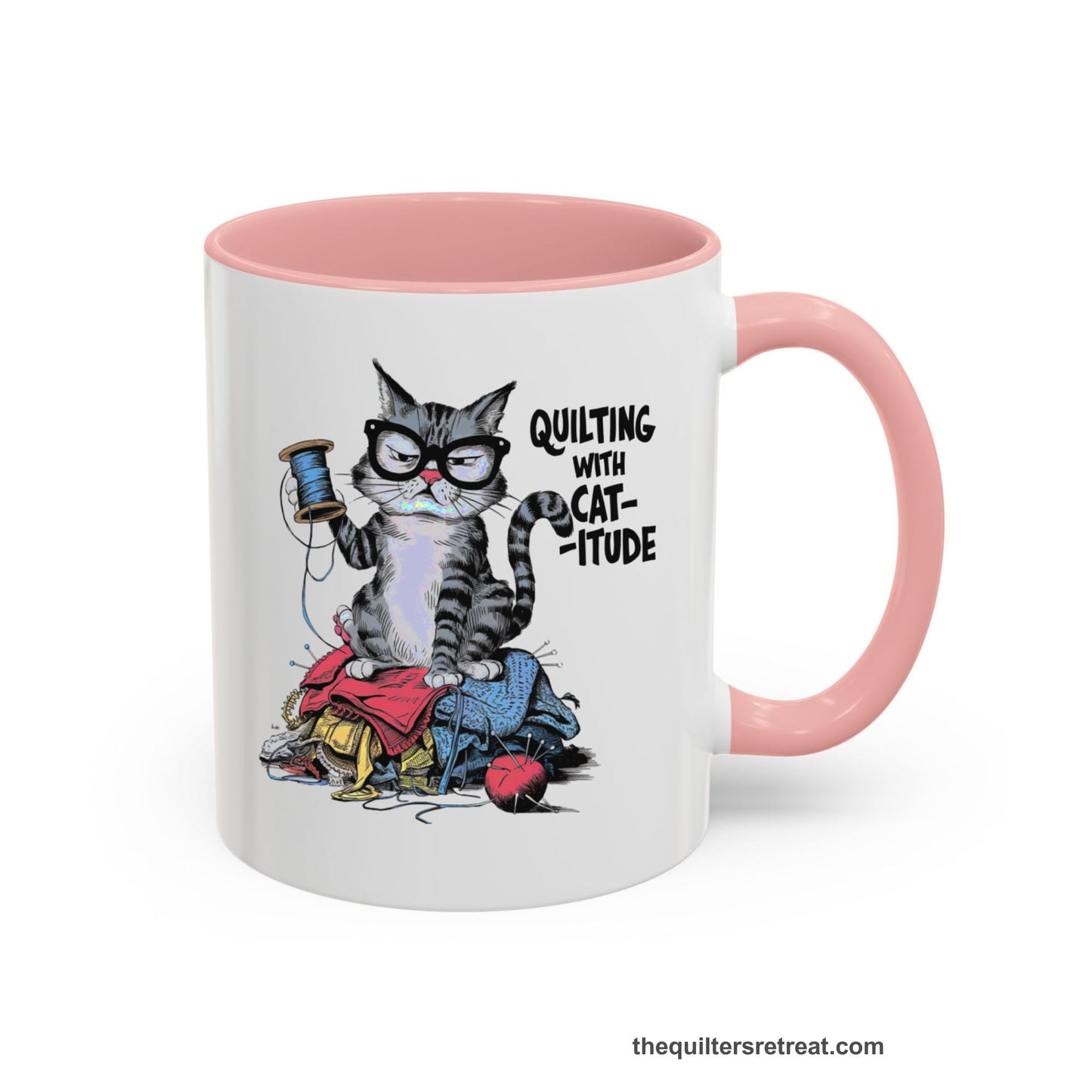 A Pink Accent Ceramic Mug featuring Quilting with Catitude design with a grumpy cat holding thread spool atop fabric pile